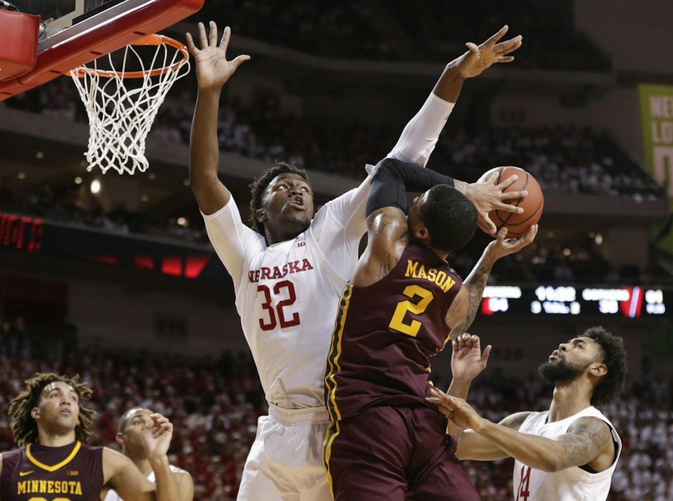 Minnesota's Nate Mason (2) is defended by Nebraska's Jordy Tshimanga (32) and Isaac Copeland (14) during the second half of an NCAA college basketball game in Lincoln, Neb., Tuesday, Dec. 5, 2017. Nebraska won 78-68.