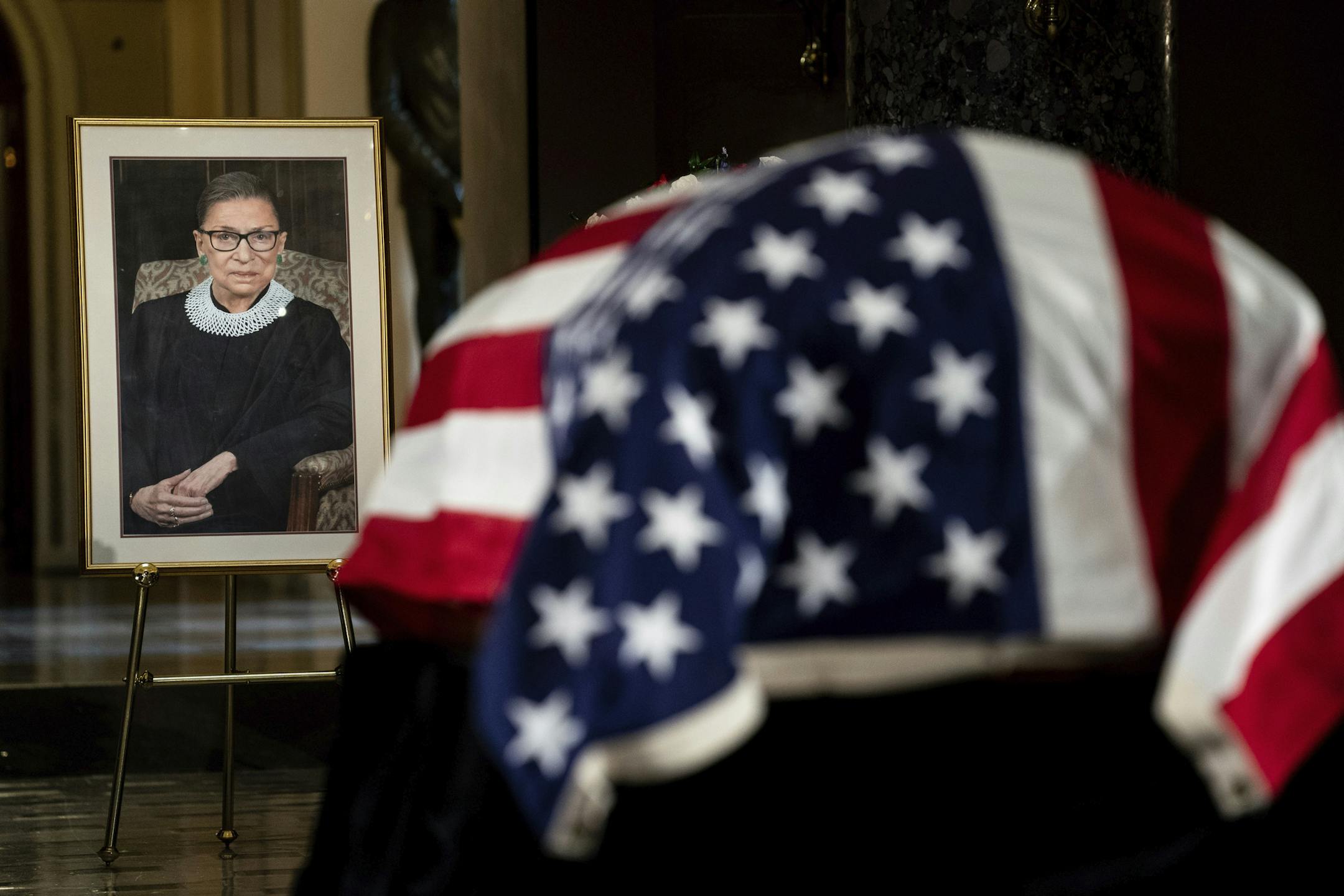 The flag-draped casket of Justice Ruth Bader Ginsburg lies in state in the U.S. Capitol on Friday, Sept. 25, 2020. Ginsburg died at the age of 87 on Sept. 18 and is the first women to lie in state at the Capitol. (Erin Schaff/The New York Times via AP, Pool)