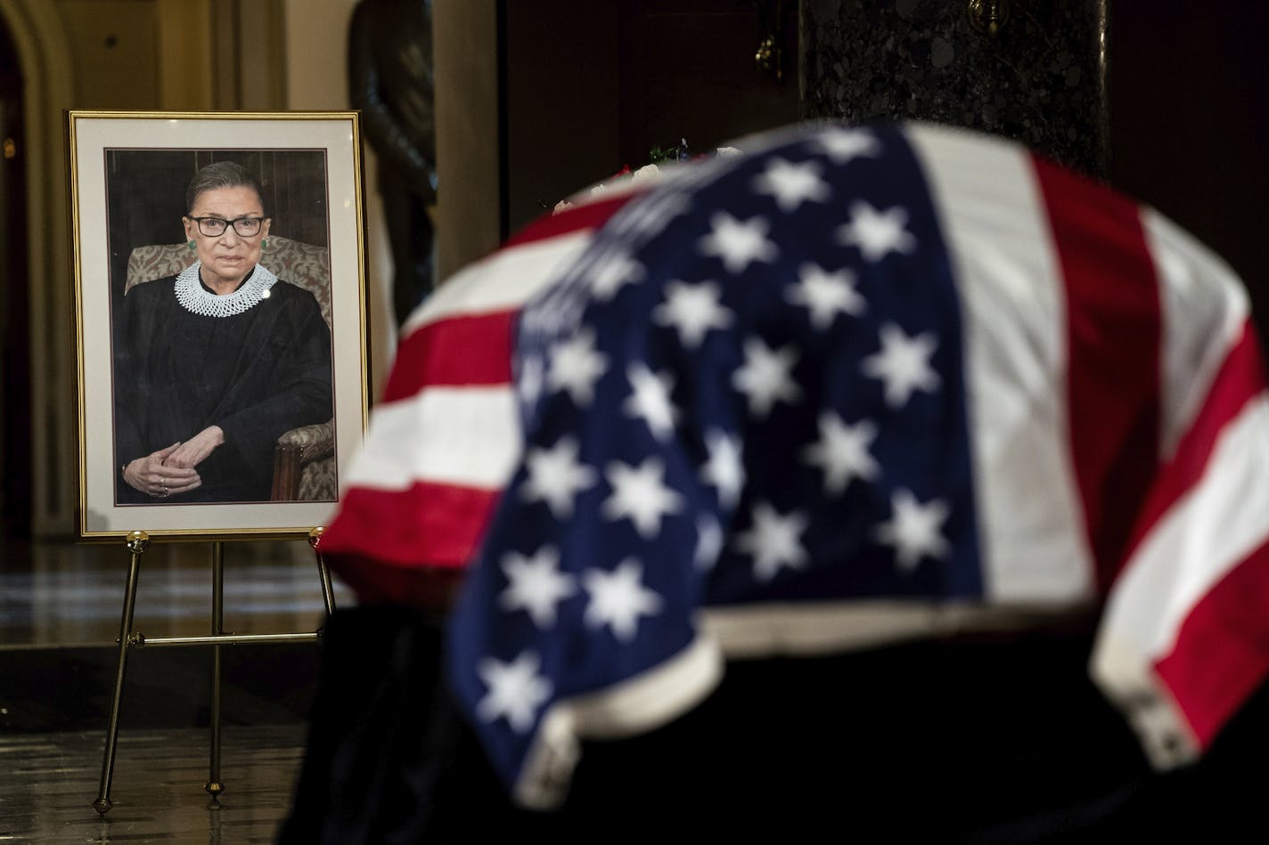 The flag-draped casket of Justice Ruth Bader Ginsburg lies in state in the U.S. Capitol on Friday, Sept. 25, 2020. Ginsburg died at the age of 87 on Sept. 18 and is the first women to lie in state at the Capitol. (Erin Schaff/The New York Times via AP, Pool)