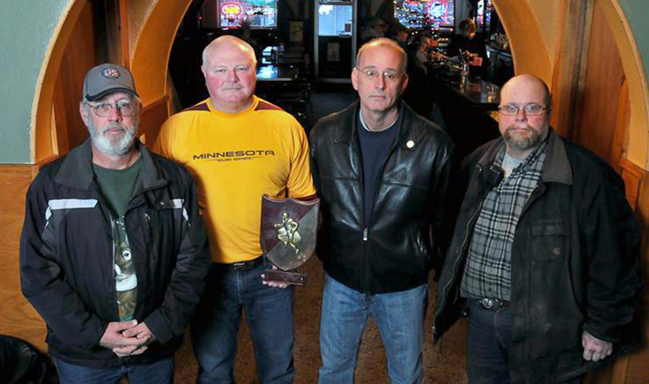 credit to Mark Sauer, special to the Star Tribune (he shot these for Patrick, not in his capacity with the newspaper up there). The trophy pic is what Eveleth won as Class A champions in 1973. -Eveleth High School 1973 State Championship football teammates from left, Jeff Perushek, Greg Salami, Bob Pazzelli, and John Rauzi pose with a commemorative plaque from their championship season at Margie's Roosevelt Bar in Eveleth Tuesday afternoon.