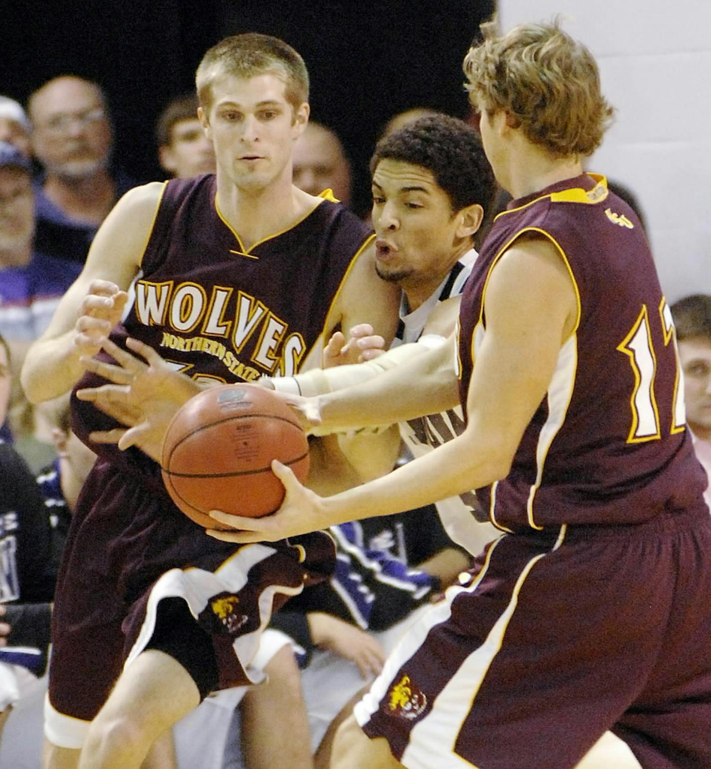 Winona State's Quincy Henderson, center, tries to break up a pass between Northern State's Kevin Ratzsch, left, and Dan DeWitt.