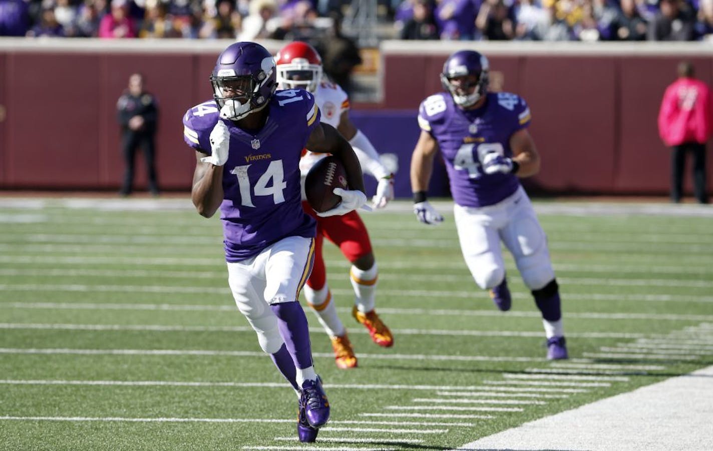 Minnesota Vikings wide receiver Stefon Diggs (14) runs with the ball during the first half of an NFL football game against the Kansas City Chiefs, Sunday, Oct. 18, 2015, in Minneapolis.