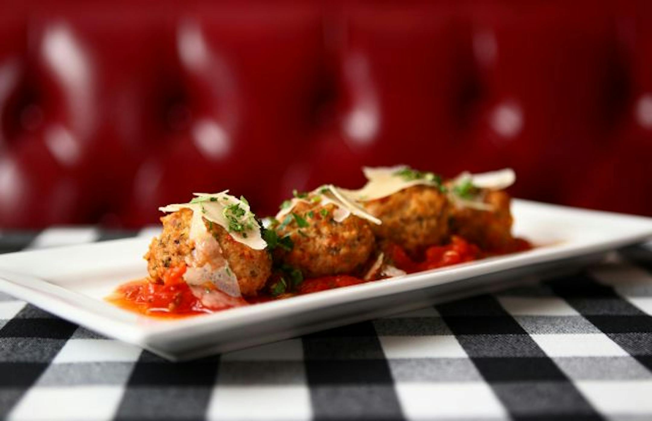 Plates don't have far to go from kitchen to table at Scusi. House-made veal meatballs with San Marzano sauce and Parmigiano Reggiano.