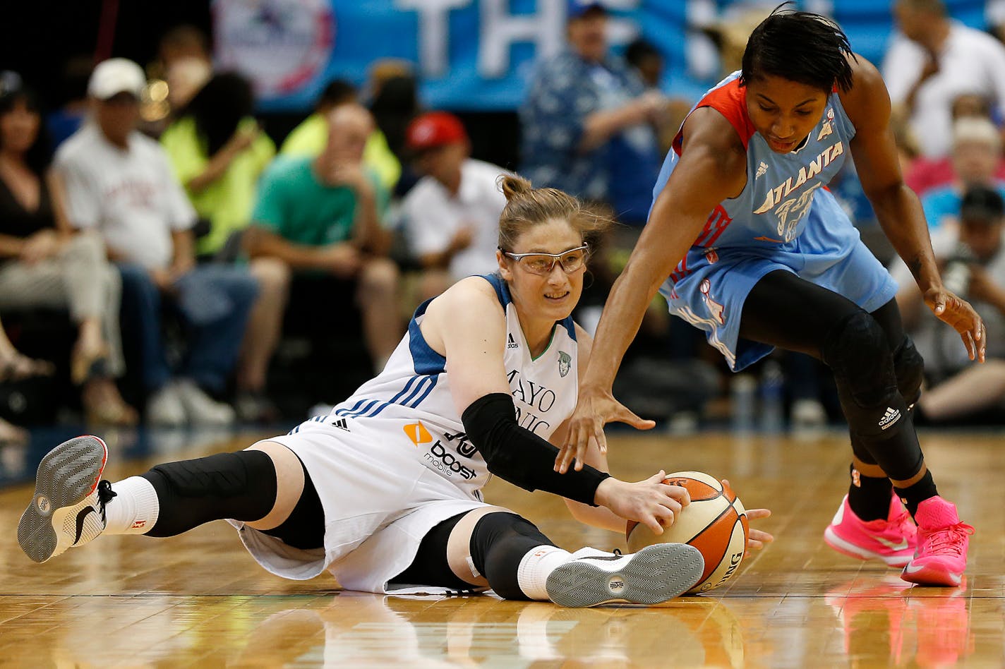 Lynx guard Lindsay Whalen, left, grabs the ball against Dream guard Angel McCoughtry during the first half of a WNBA basketball game, Friday, July 31, 2015, in Minneapolis.