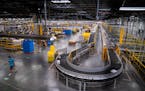 Shown is Amazon’s larger fulfillment center in Shakopee. The Brooklyn Park warehouse, though, smaller will rely on automation to help workers as the