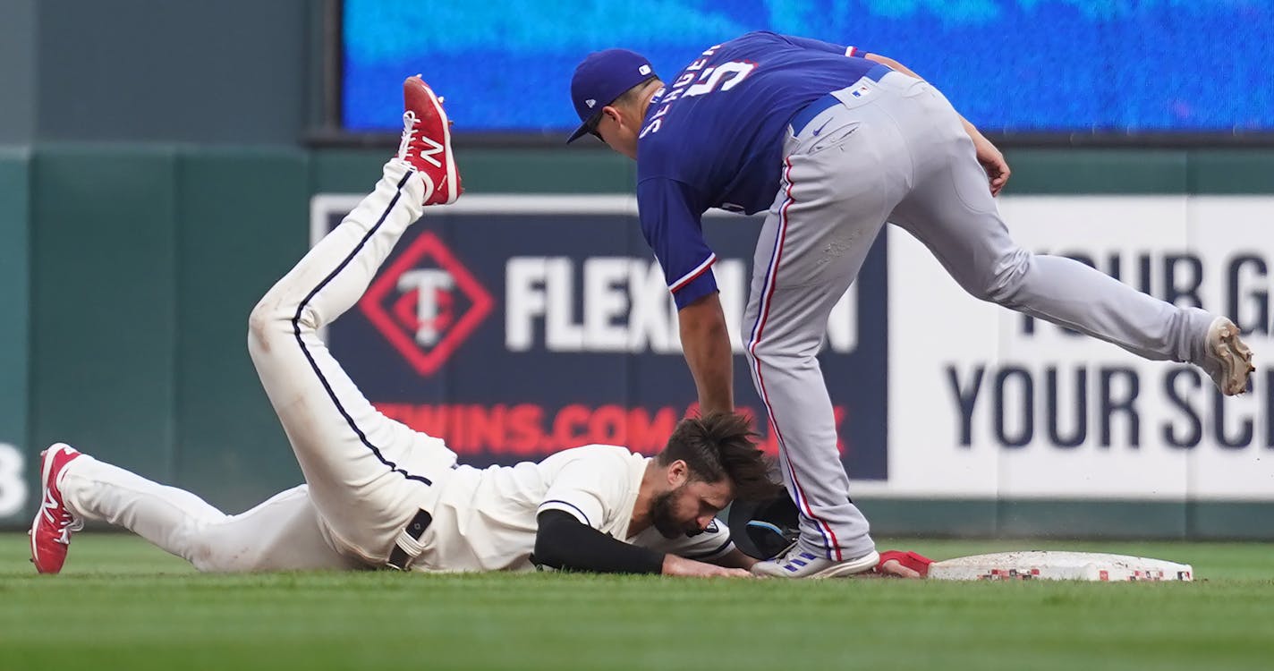 Minnesota Twins left fielder Joey Gallo (13) is doubled off second base by Texas Rangers shortstop Corey Seager (5) in the 11th inning in Minneapolis, Minn., on Sunday, Aug. 27, 2023. Texas Rangers take on the Minnesota Twins at Target Field.] RICHARD TSONG-TAATARII • richard.tsong-taatarii @startribune.com