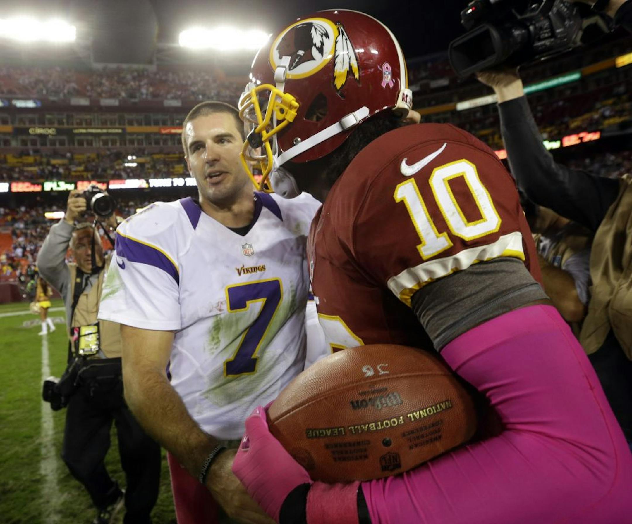 Washington quarterback Robert Griffin III (10) greets Minnesota quarterback Christian Ponder (7) after Sunday's game.