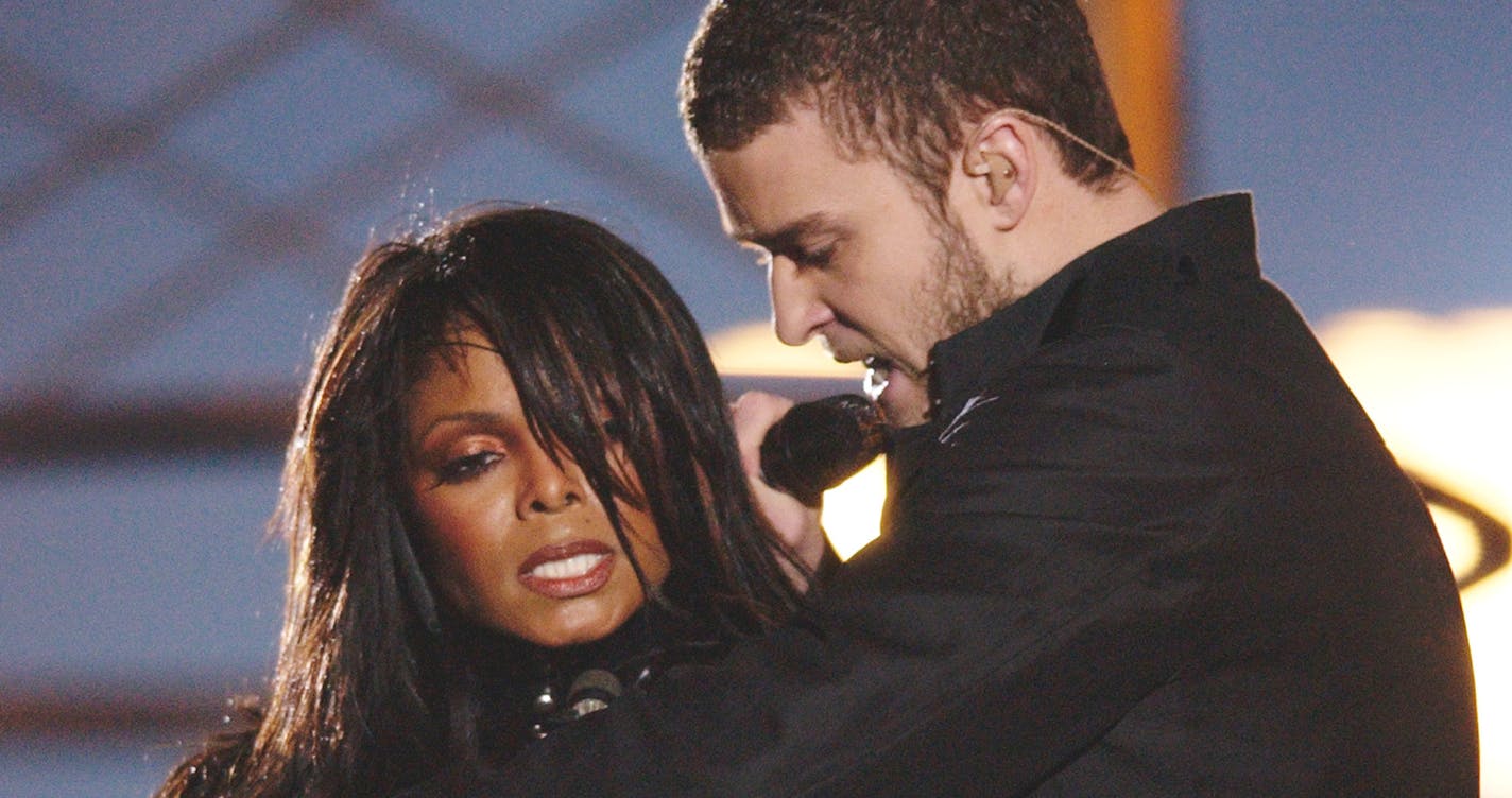 Justin Timberlake reaches across Janet Jackson during their performancs just before he pulled off the covering to her right breast, which was partially obscured by a sun-shaped, metal nipple decoration during the half time performance at Super Bowl XXXVIII in Houston, Sunday Feb. 1, 2004. (AP Photo/David Phillip)