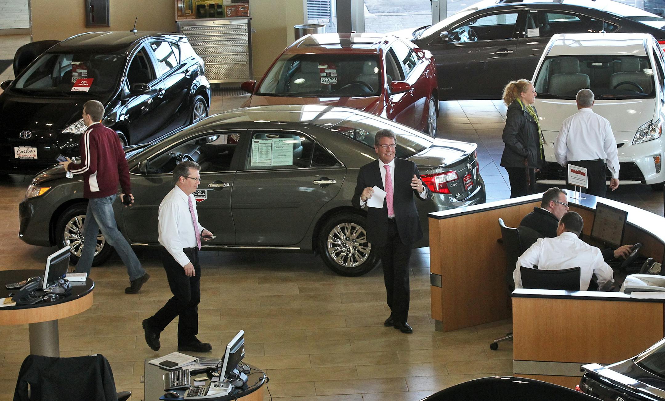 There has been an upswing in hiring of auto dealer employees. Toyota in Coon Rapids has hired eight new sales people in the past six months. Sales people busy showing customers new Toyotas on the showroom floor. (MARLIN LEVISON/STARTRIBUNE(mlevison@startribune.com (cq program)