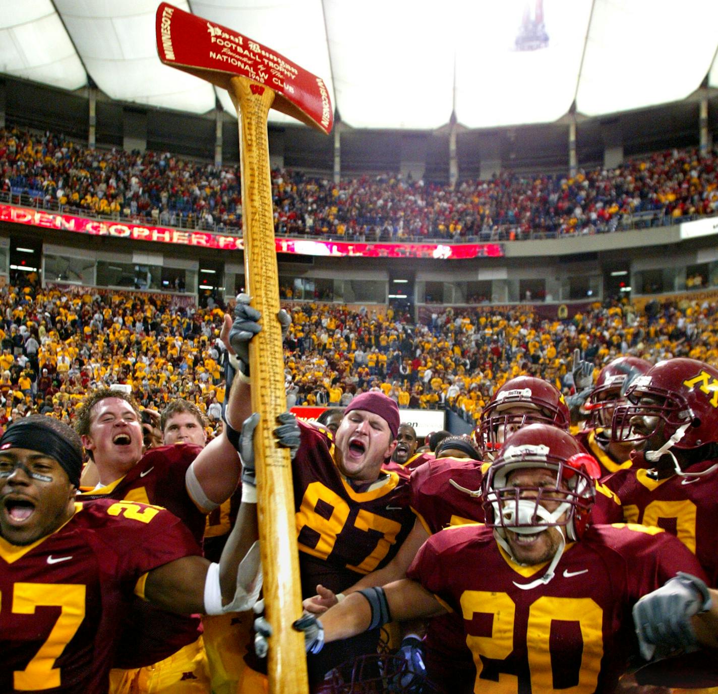 11/08/03 - Gopher football vs. Wisconsin - Minnesota wins 37-34. IN THIS PHOTO: Members of the Gopher football team lift high the Paul Bunyan axe that will be heading back to the Minnesota trophy case after they defeated Wisconsin on a last second field goal. ORG XMIT: MIN2013041713385505 ORG XMIT: MIN1511271902561138