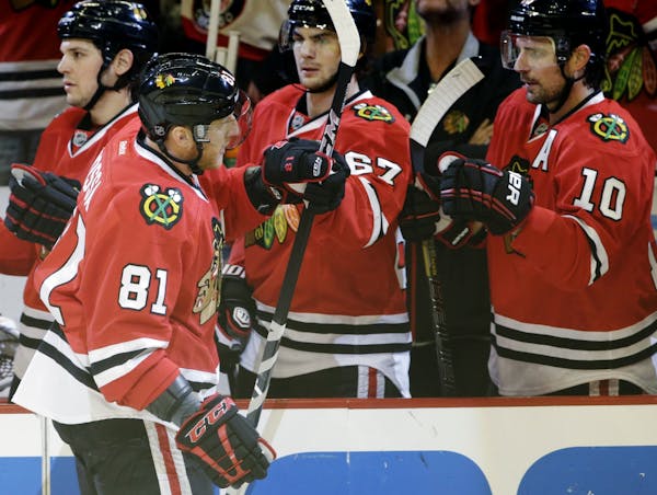 Chicago's Marian Hossa (81) celebrated with teammates after scoring a goal against the WIld during the first period of Game 5. The Blackhawks won 5-1 