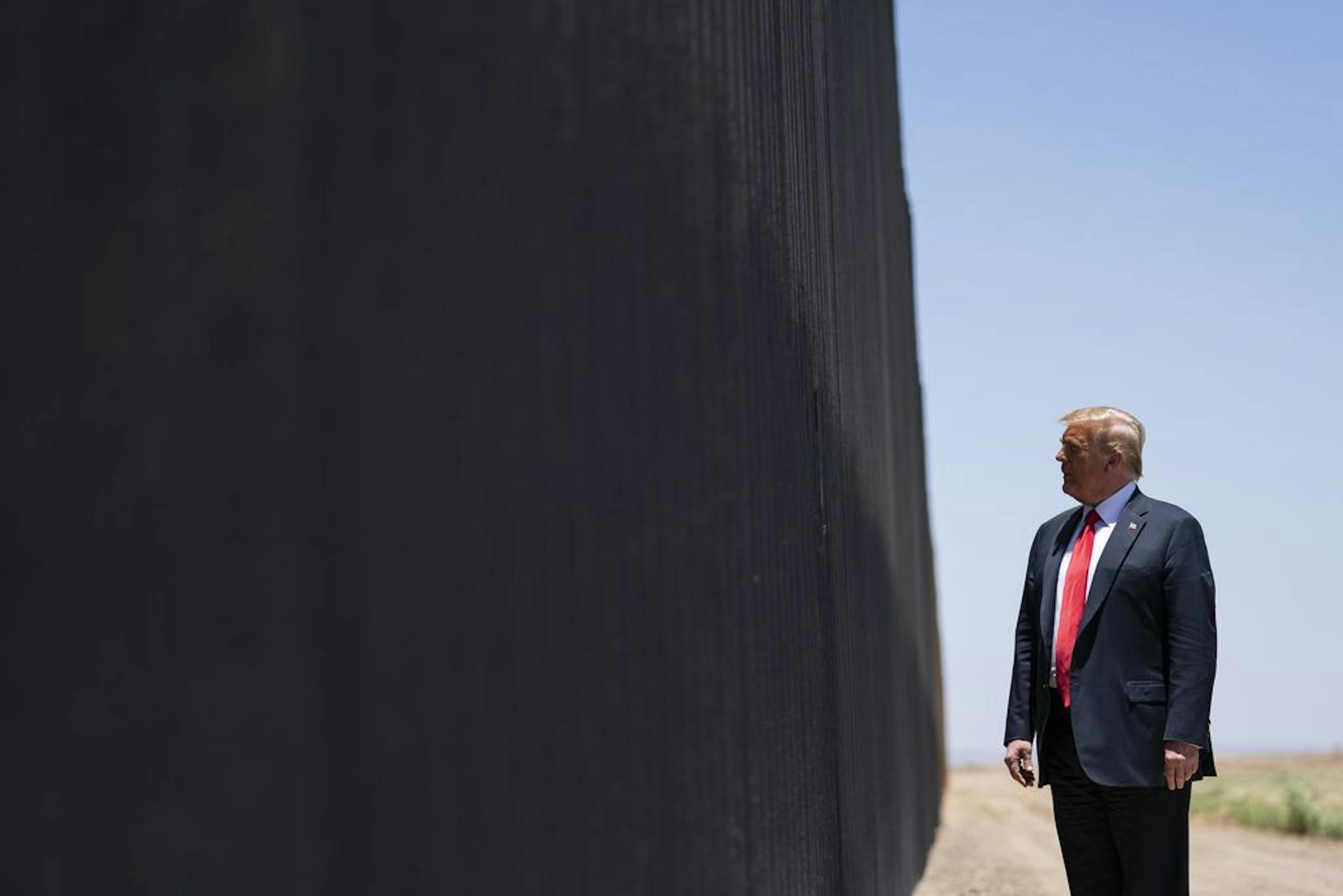 FILE - In this June 23, 2020, file photo, President Donald Trump tours a section of the border wall in San Luis, Ariz. A federal appeals court has ruled against the Trump administration in its transfer of military money to build sections of the U.S. border wall with Mexico.