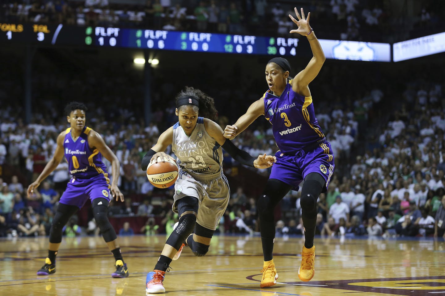 Lynx forward Maya Moore drove around Sparks center Candace Parker in the first half of Game 1 of the WNBA Finals on Sunday.