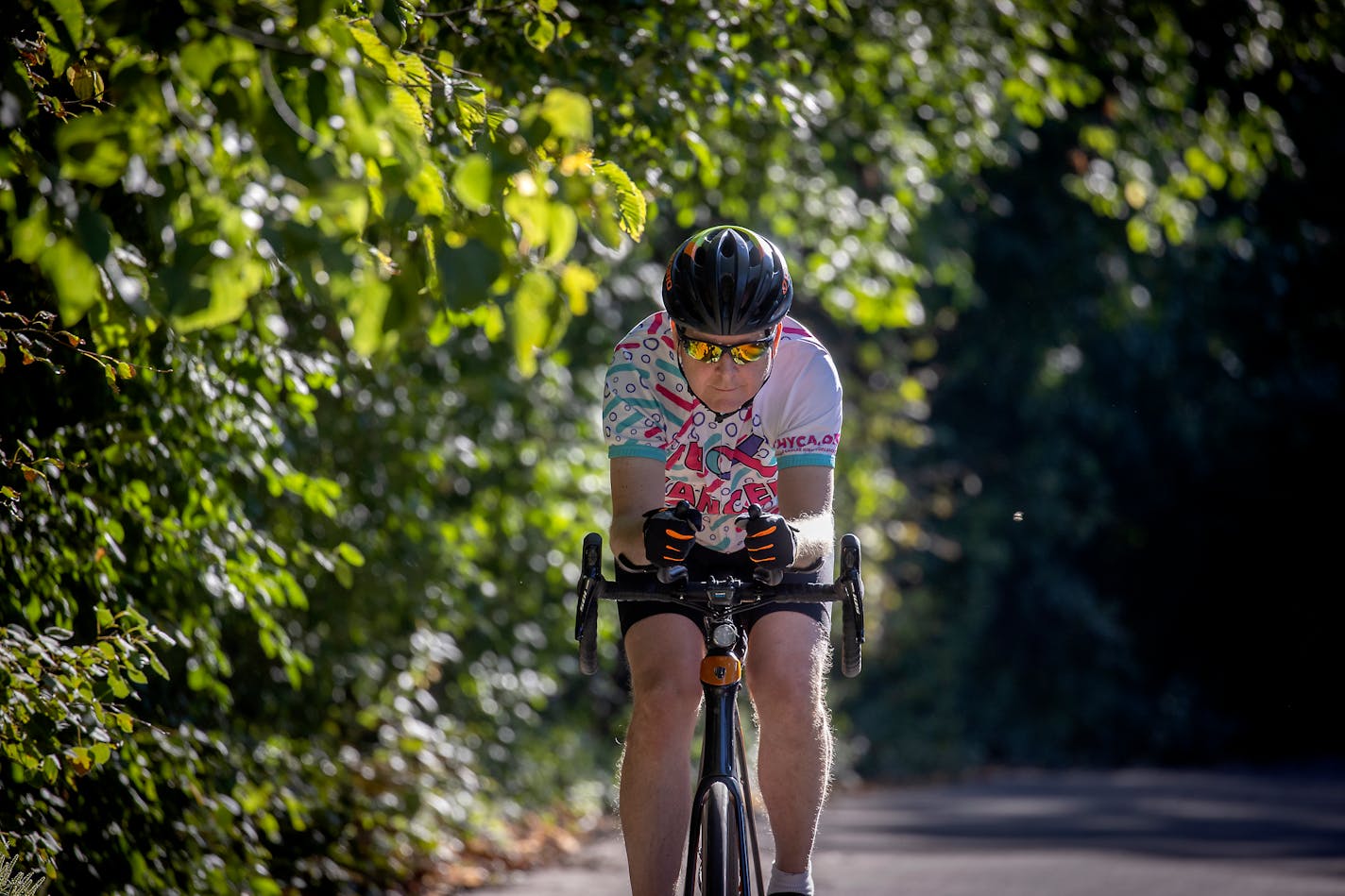 Drayton rode his bike Monday near his home. He has trained daily for his September ride from the North Shore to Iowa.