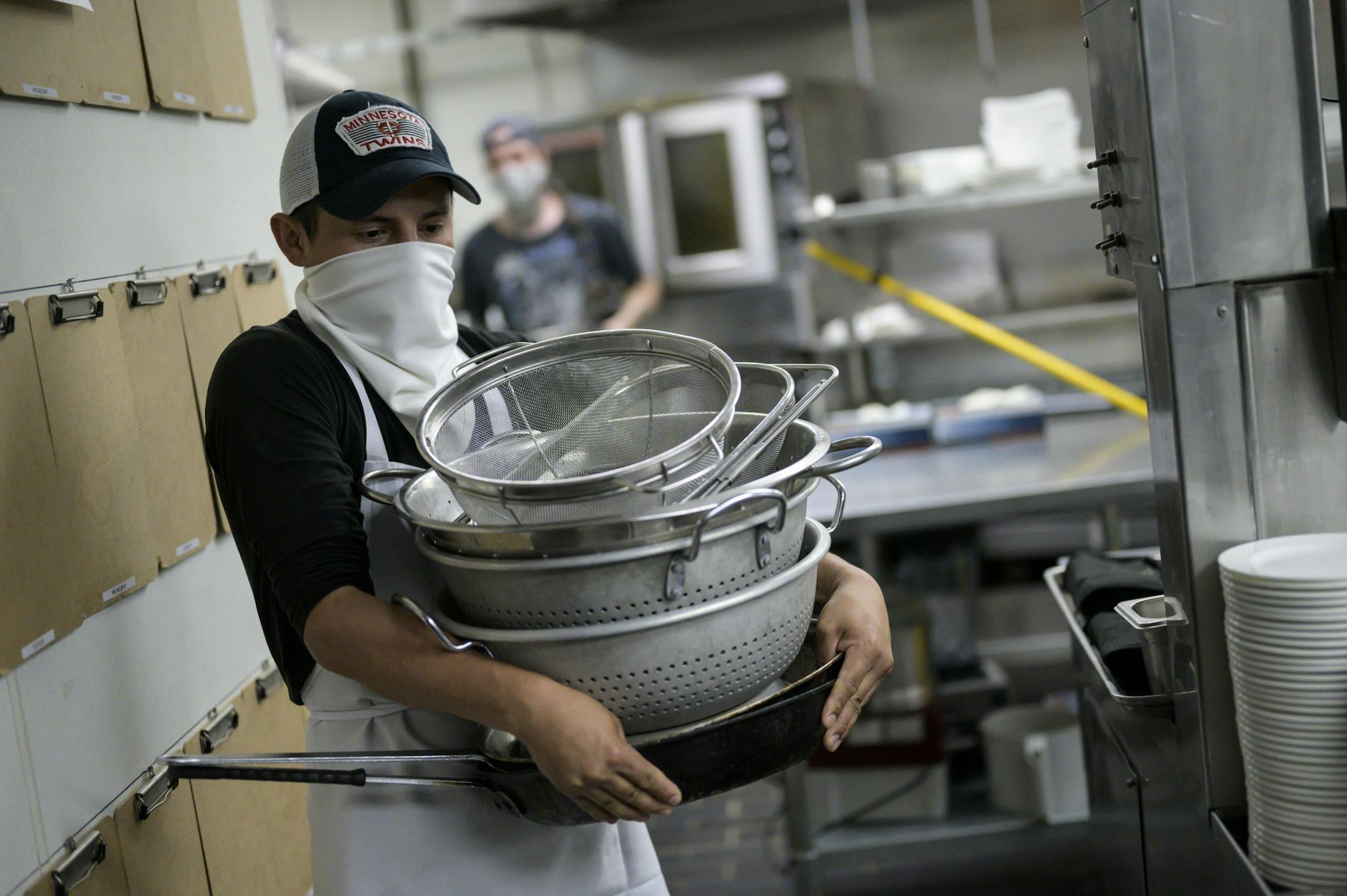 Andres Espinoza, an employee at Fhima's worked on emptying the kitchen of all items before a deep cleaning, which involves fumigation. aaron.lavinsky@startribune.com Restaurants react to Gov. Walz's reopening order whatever it is. We photograph Fhima's as workers prepare for possible reopening on Wednesday, May 20, 2020 in Minneapolis, Minn.
