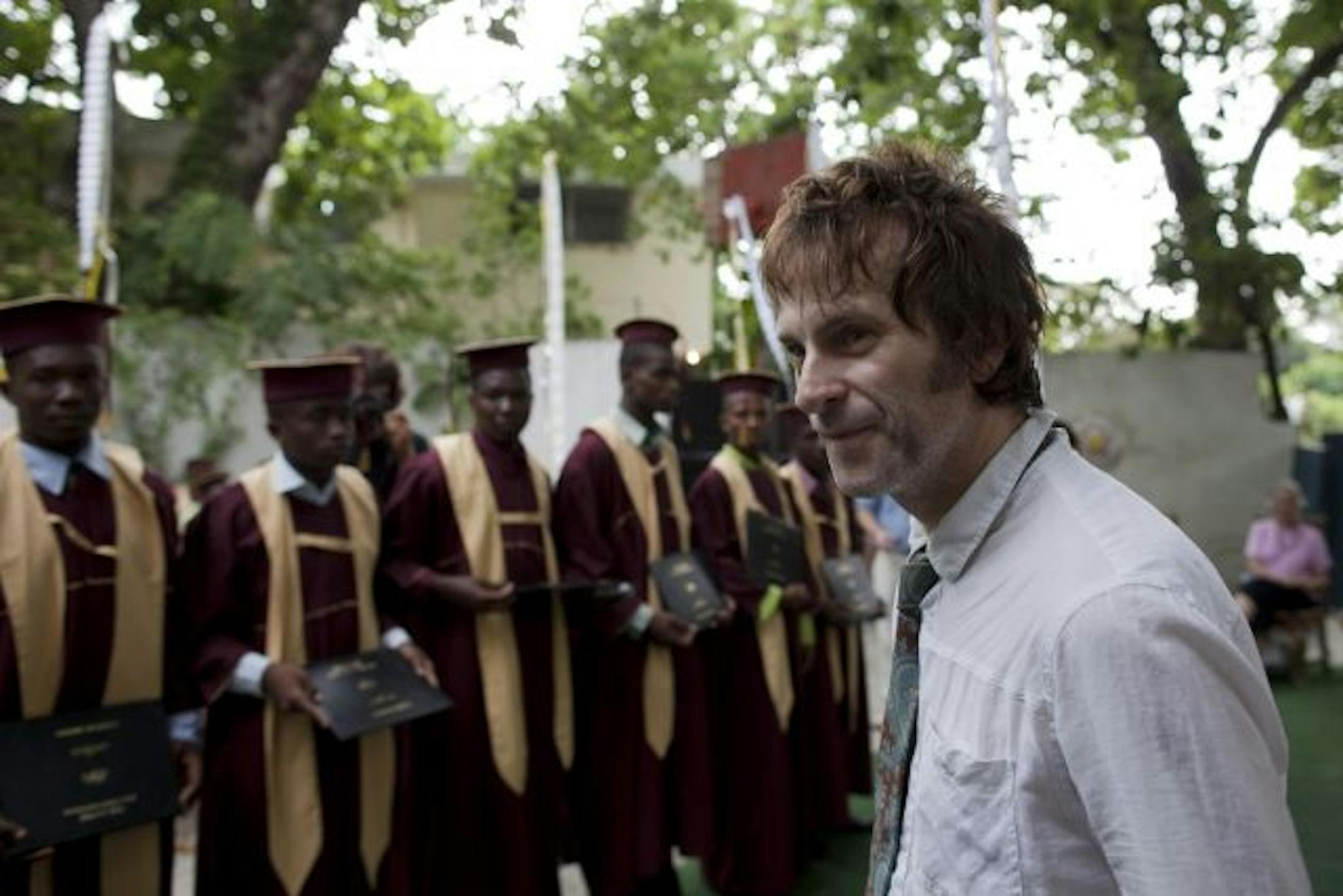 Guns N' Roses musician Tommy Stinson attends the graduation ceremony for former street youth at the Timkatec school in Port-au-Prince, Haiti, Saturday July 31, 2010.