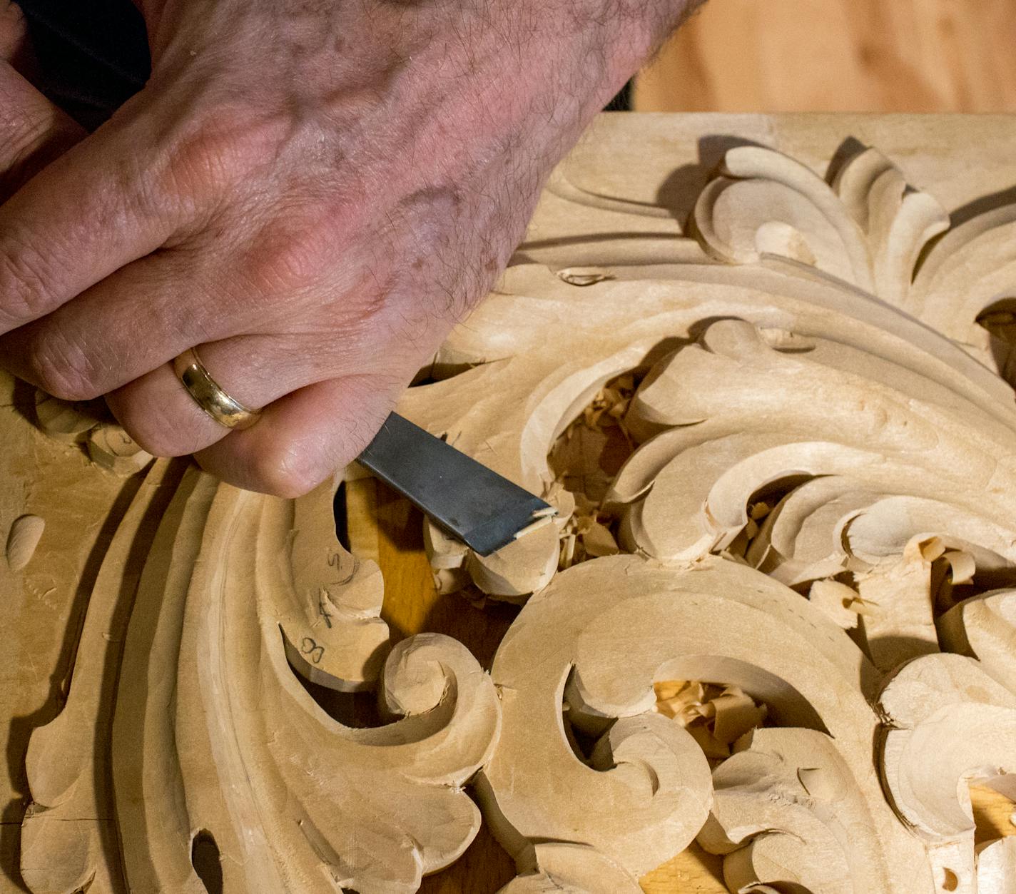 Holmen used a chisel to carve a Norwegian-style acanthus.