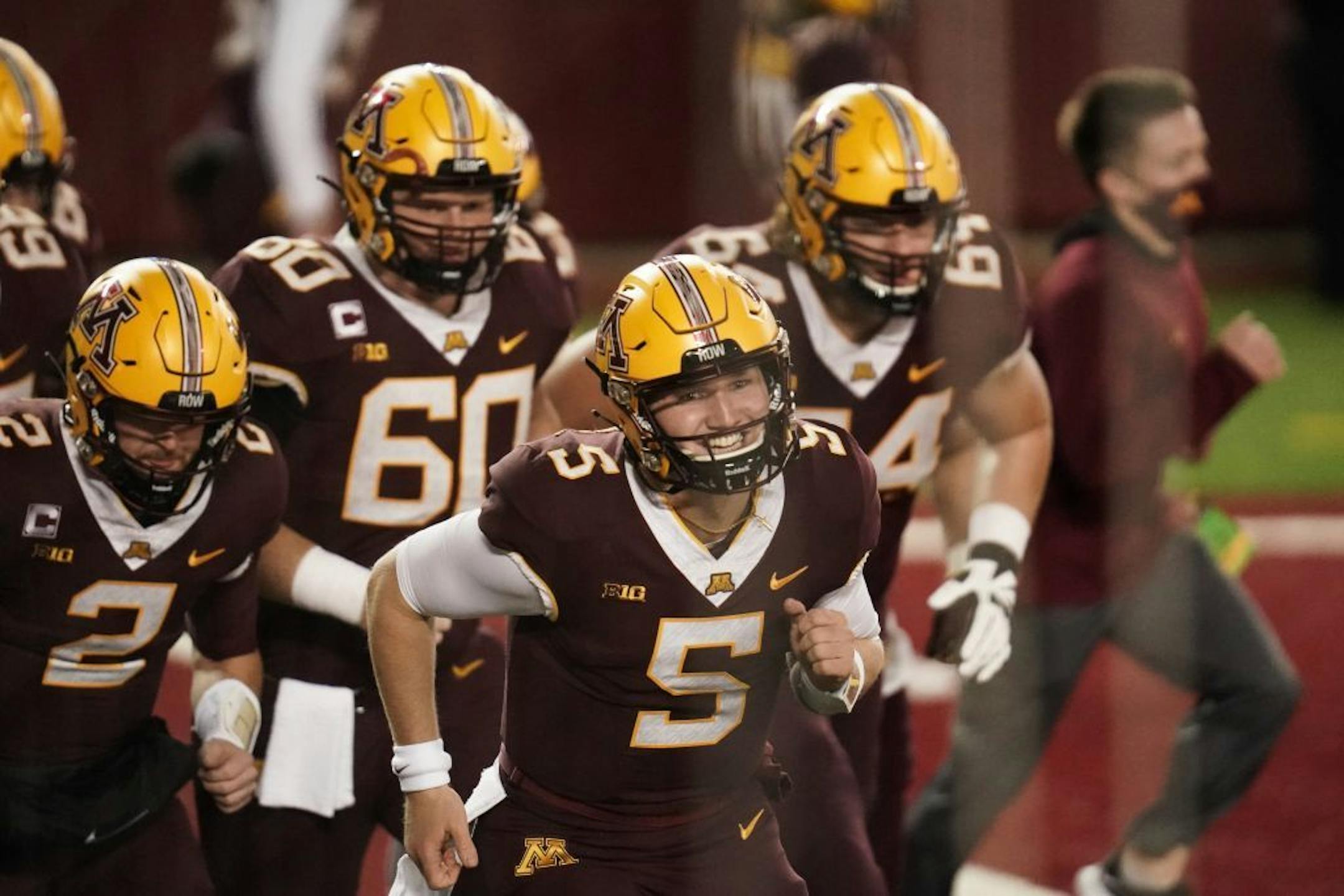 Minnesota Gophers linebacker Trenton Guthrie (5) and his teammates warmed up before the game.