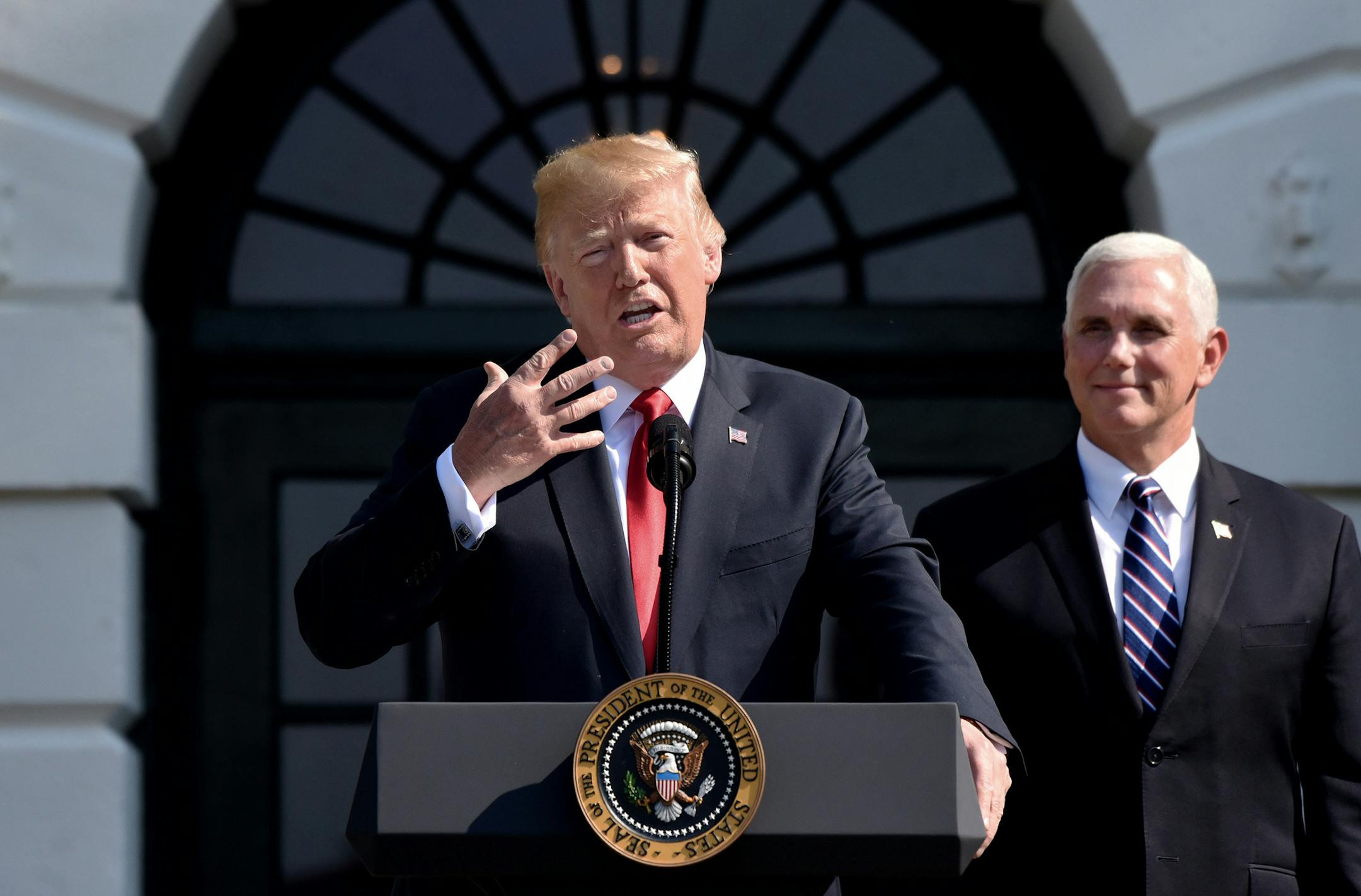U.S. President Donald Trump comments on the 4.1 percent economic growth for the second quarter as Vice President Mike Pence looks on during a statement in the South Lawn of the White House July 27, 2018 in Washington, D.C. (Olivier Douliery/Abaca Press/TNS) ORG XMIT: 1238234