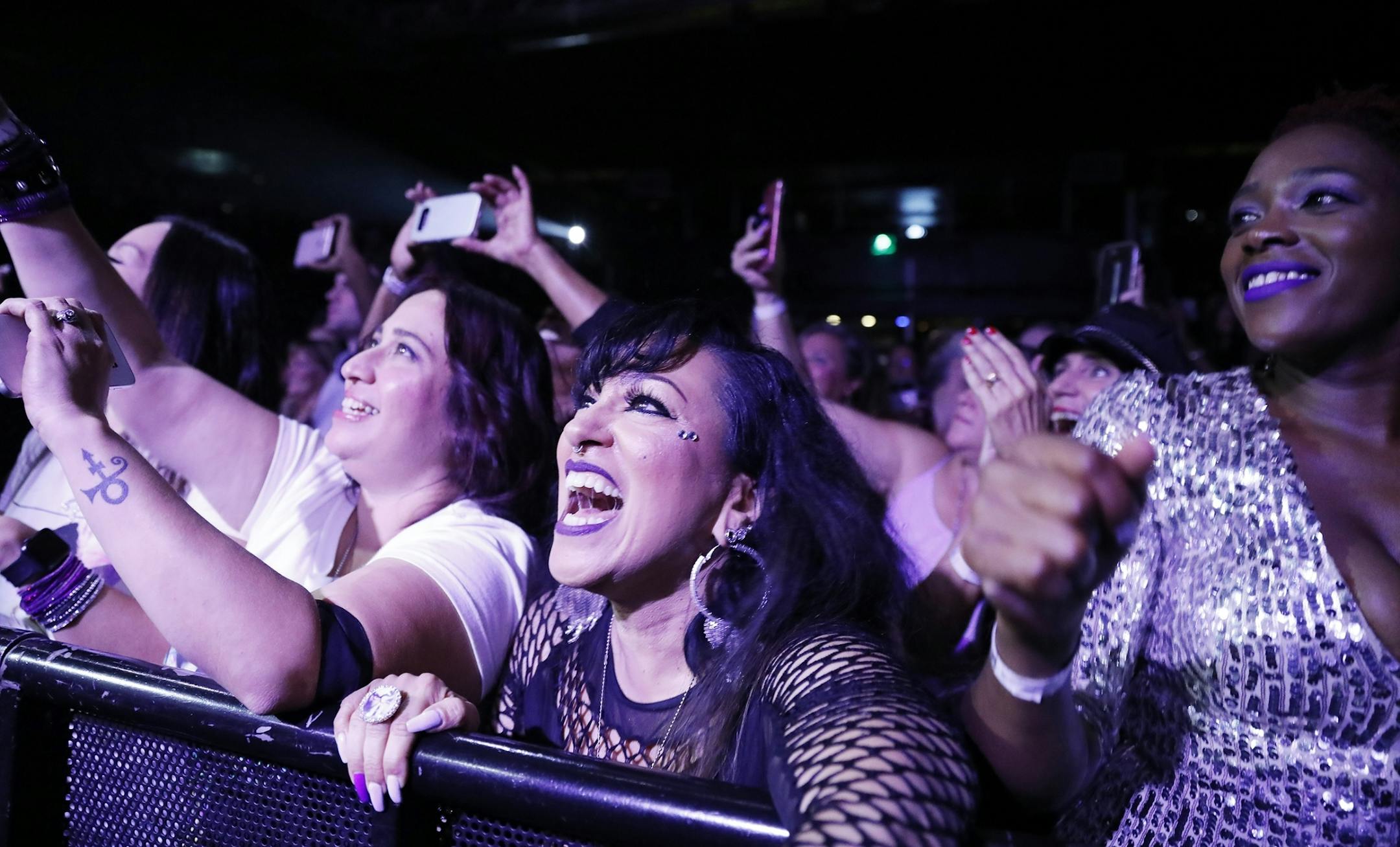 Fans sing along during the New Power Generation show.