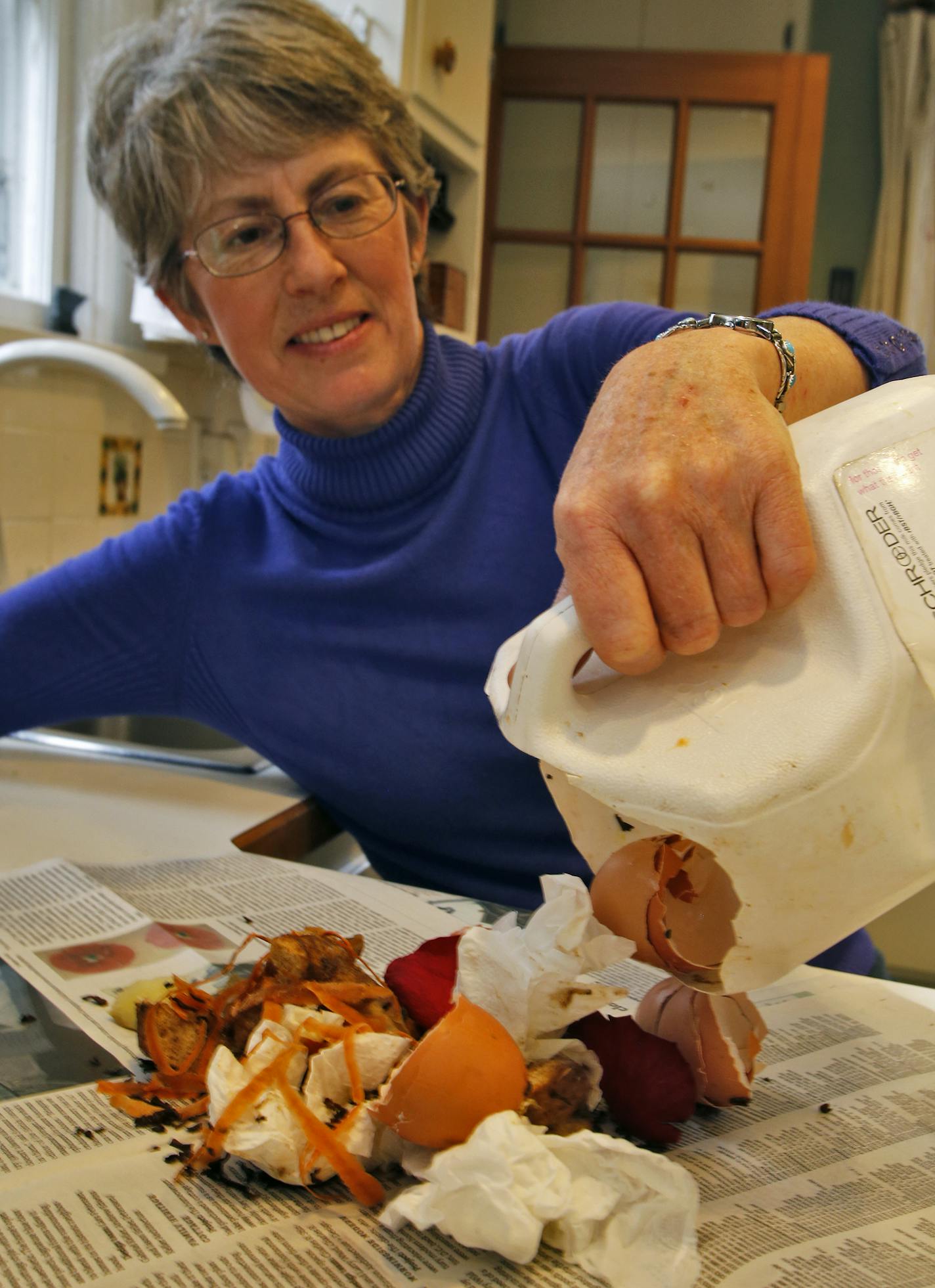 Dolezal dumps organic wastes onto a newspaper in preparation for disposal. ] Dottie Dolezal of Minneapolis disposes of her organic wastes in green style. . (MARLIN LEVISON/STARTRIBUNE(mlevison@startribune.com)