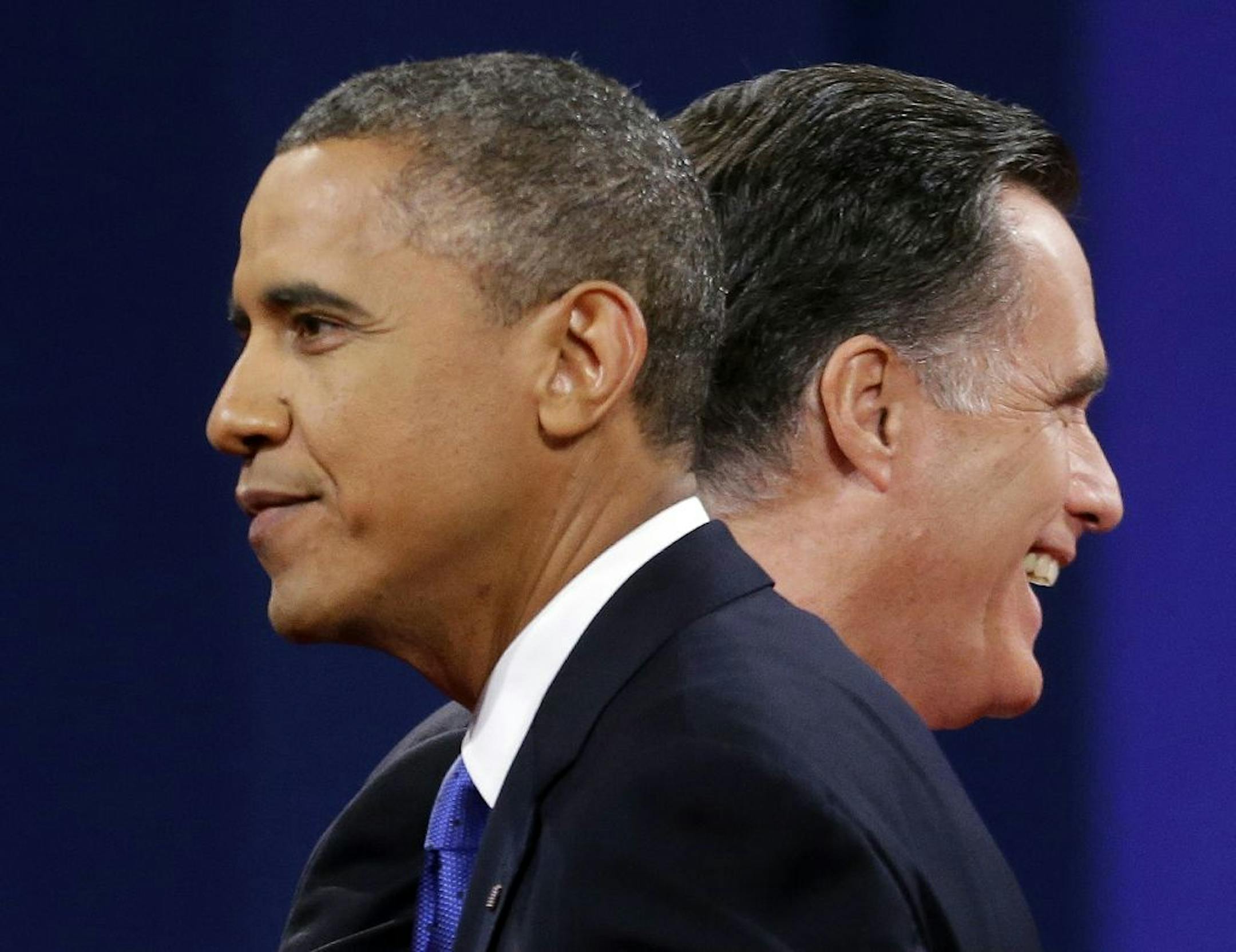 Republican presidential candidate, former Massachusetts Gov. Mitt Romney and President Barack Obama walks past each other on stage at the end of the last debate at Lynn University, Monday, Oct. 22, 2012, in Boca Raton, Fla.