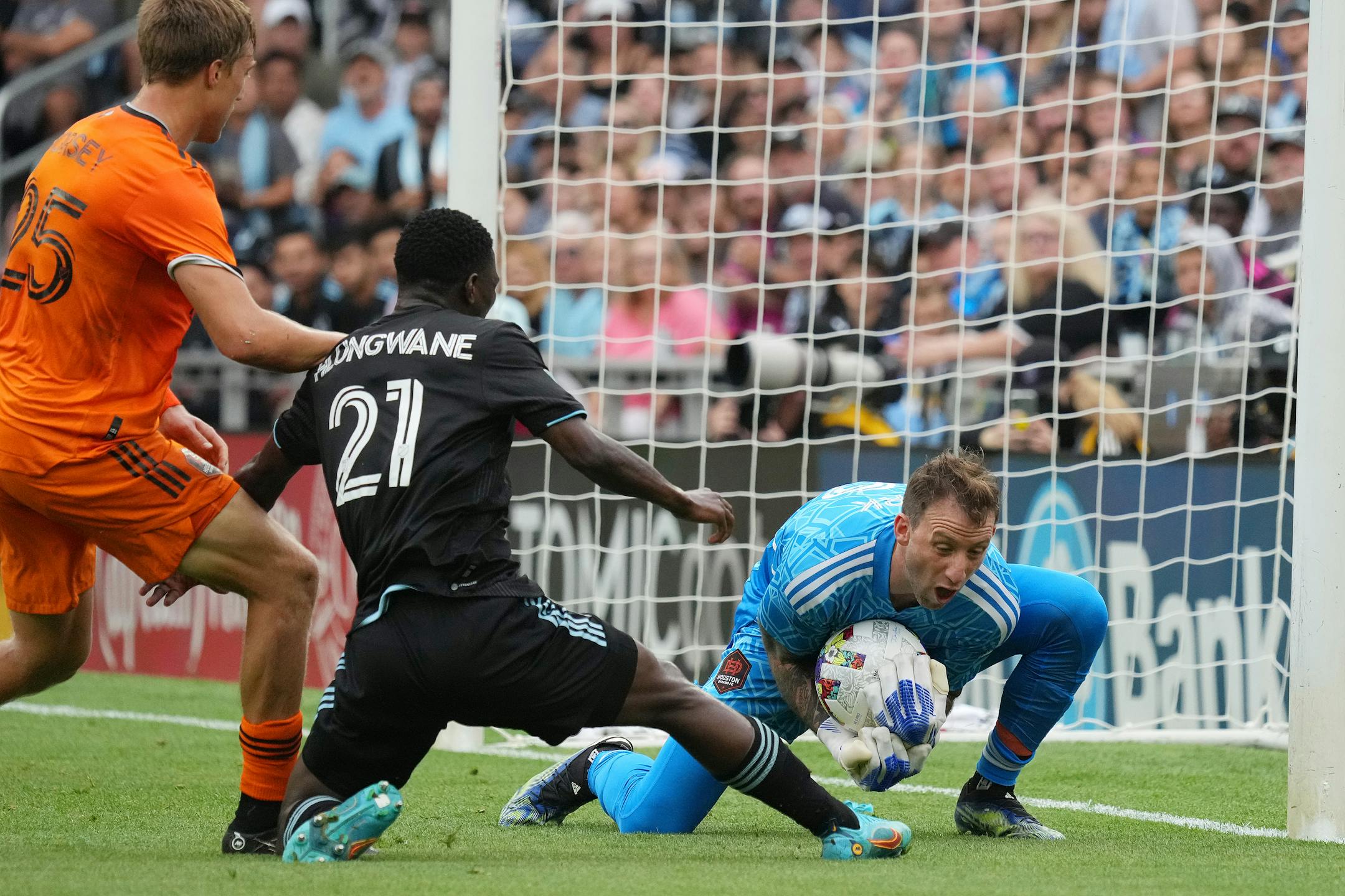 Houston Dynamo goalkeeper Steve Clark (12) makes a save on a shot by Minnesota United forward Bongokuhle Hlongwane (21) in the first half of an MLS game between Minnesota United and the Houston Dynamo.