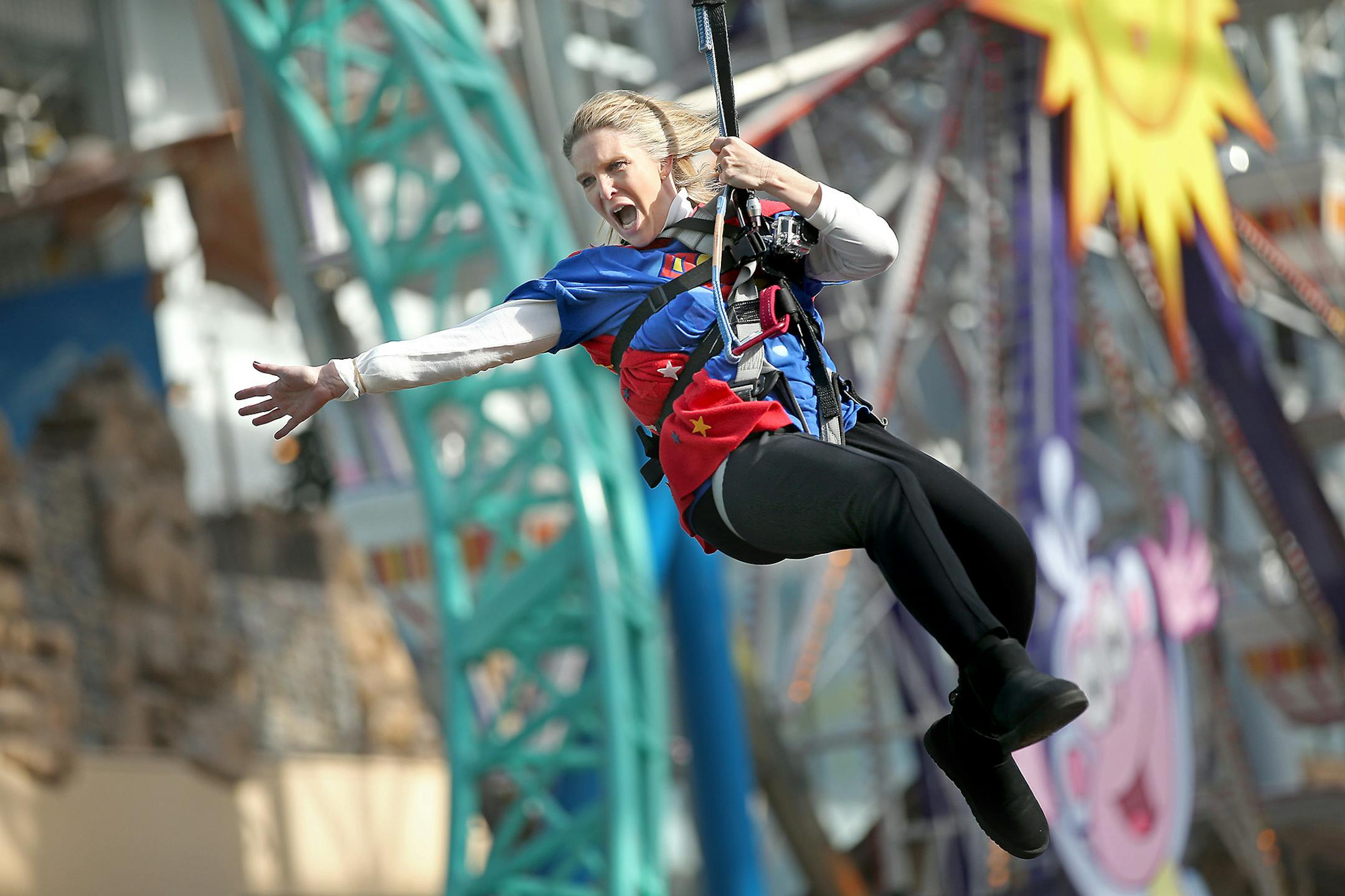 Dressed as a super hero, Hilltop Elementary School's Sue Vallafskey swung high above her students on the Mall of America's zip line Thursday. Vallafskey joined other school principals and teachers to gain awareness for "Give to the Max" day, the annual giving extravaganza that raised $17 million in 24 hours last year.