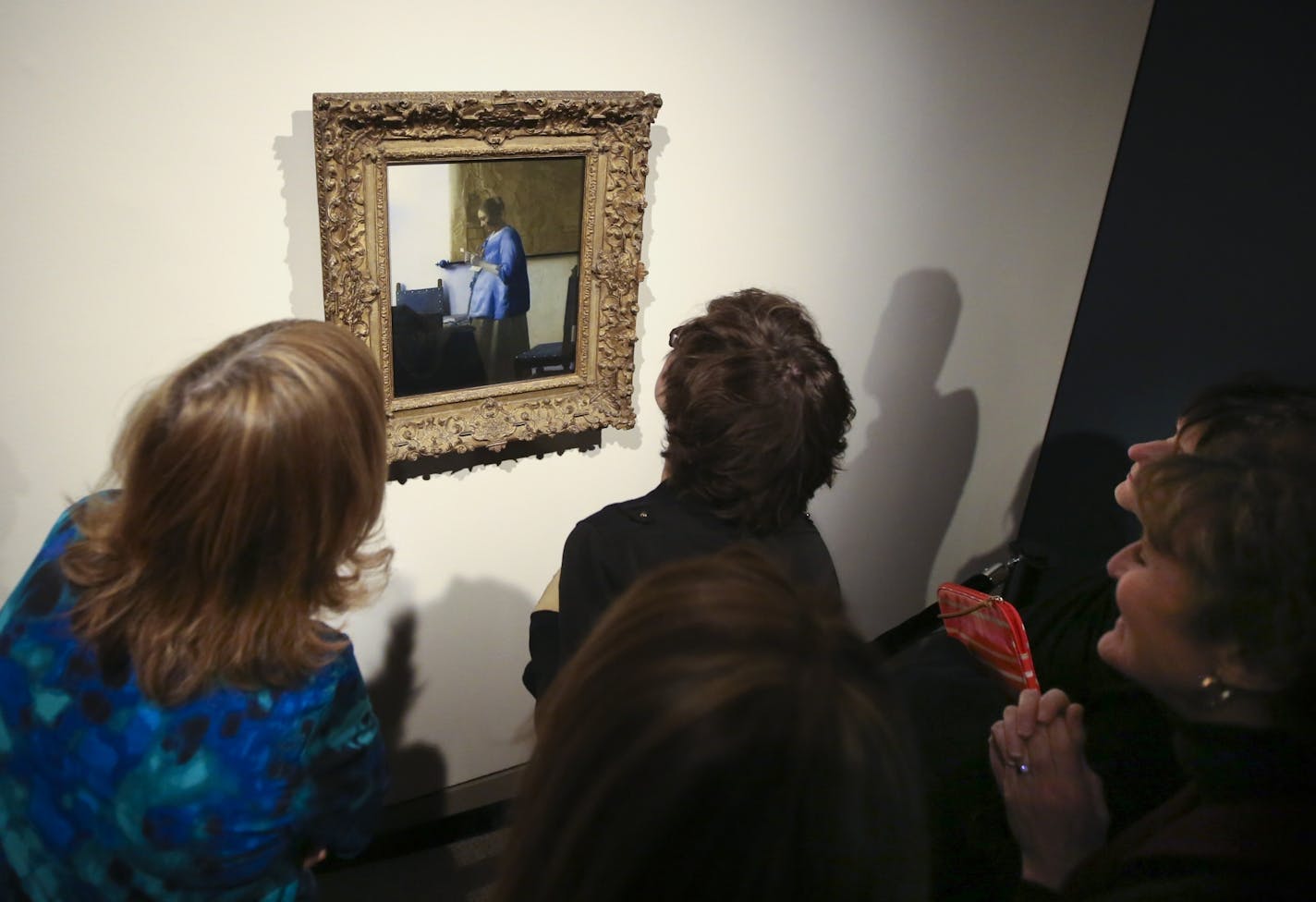 MIA staff members got a close up look at Johannes Vermeer's Woman in Blue Reading a Letter at the staff unveiling of the Minneapolis Institute of Arts' first big "surprise" of its centennial year on Friday, January 16, 2015, in Mineapolis, Minn.