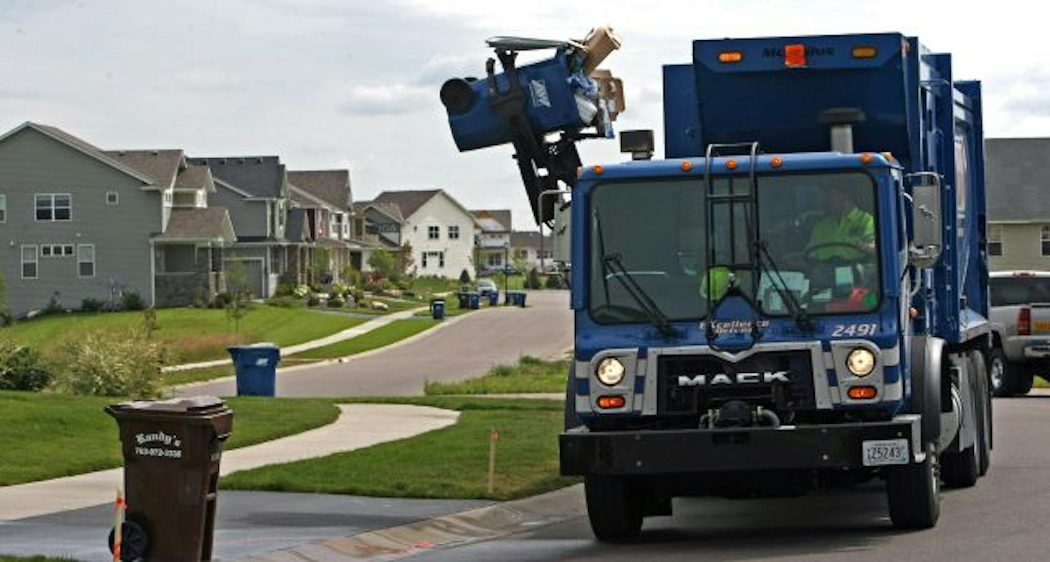 Will Kuehn of Allied Waste Services used a mechanical arm to lift co-mingled recycling into his truck near the intersection of Urbandale Lane North and 62nd Place North in Maple Grove.