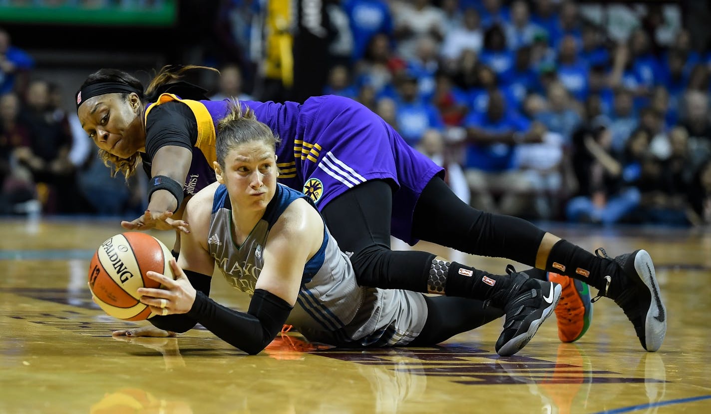 Minnesota Lynx guard Lindsay Whalen (13) and Los Angeles Sparks guard Odyssey Sims (1) battled for a loose ball in the fourth quarter, but Whalen was able to call the timeout in time.