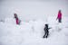 Three kids played on a large pile of snow during the John Beargrease Cub Run on Saturday in Two Harbors, MN.