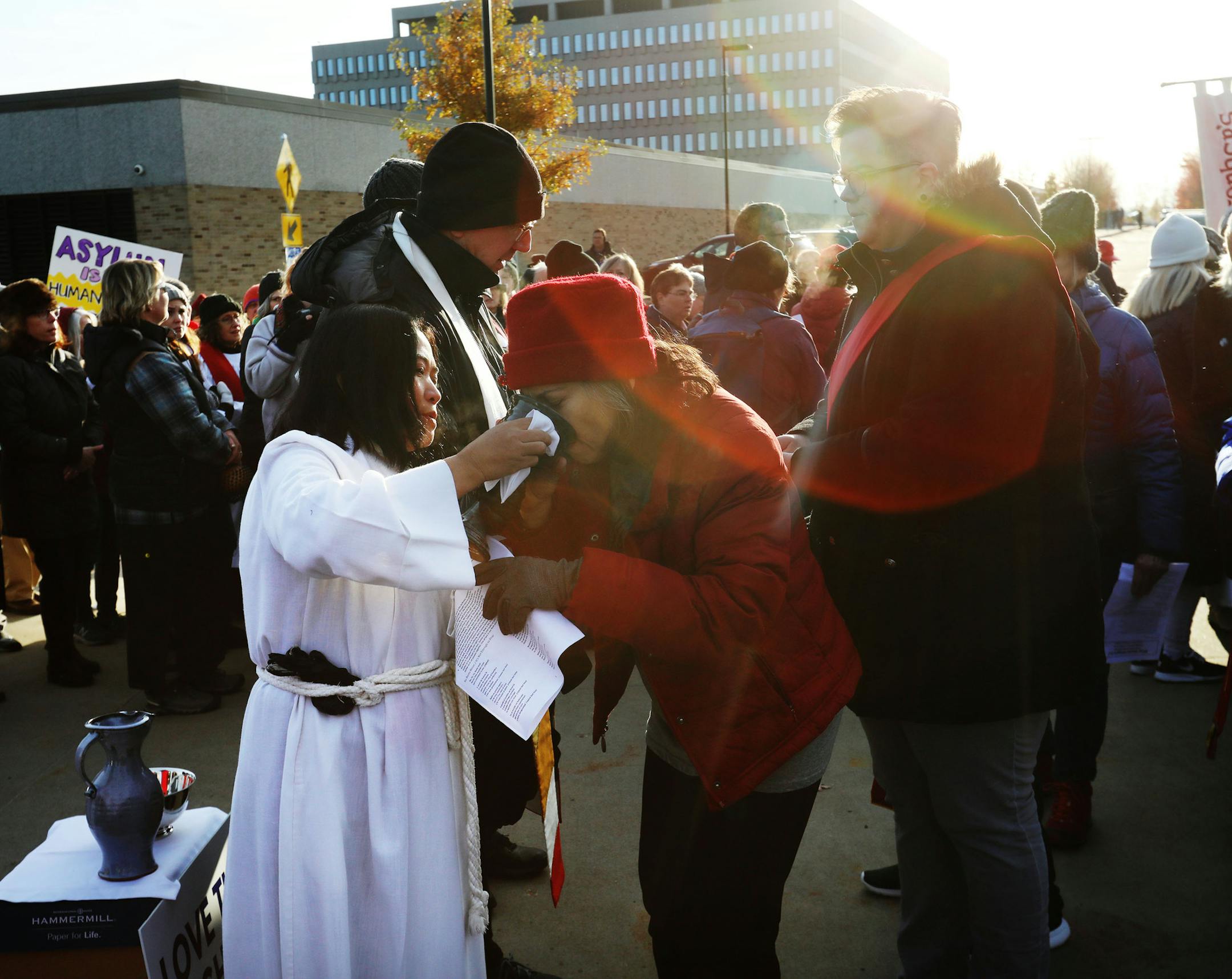 Lay person Hser Moo offered wine during a communion outside the Whipple Federal Building Tuesday, Oct. 29, 2019, in St. Paul, MN. DAVID JOLES • david.joles@startribune.com
