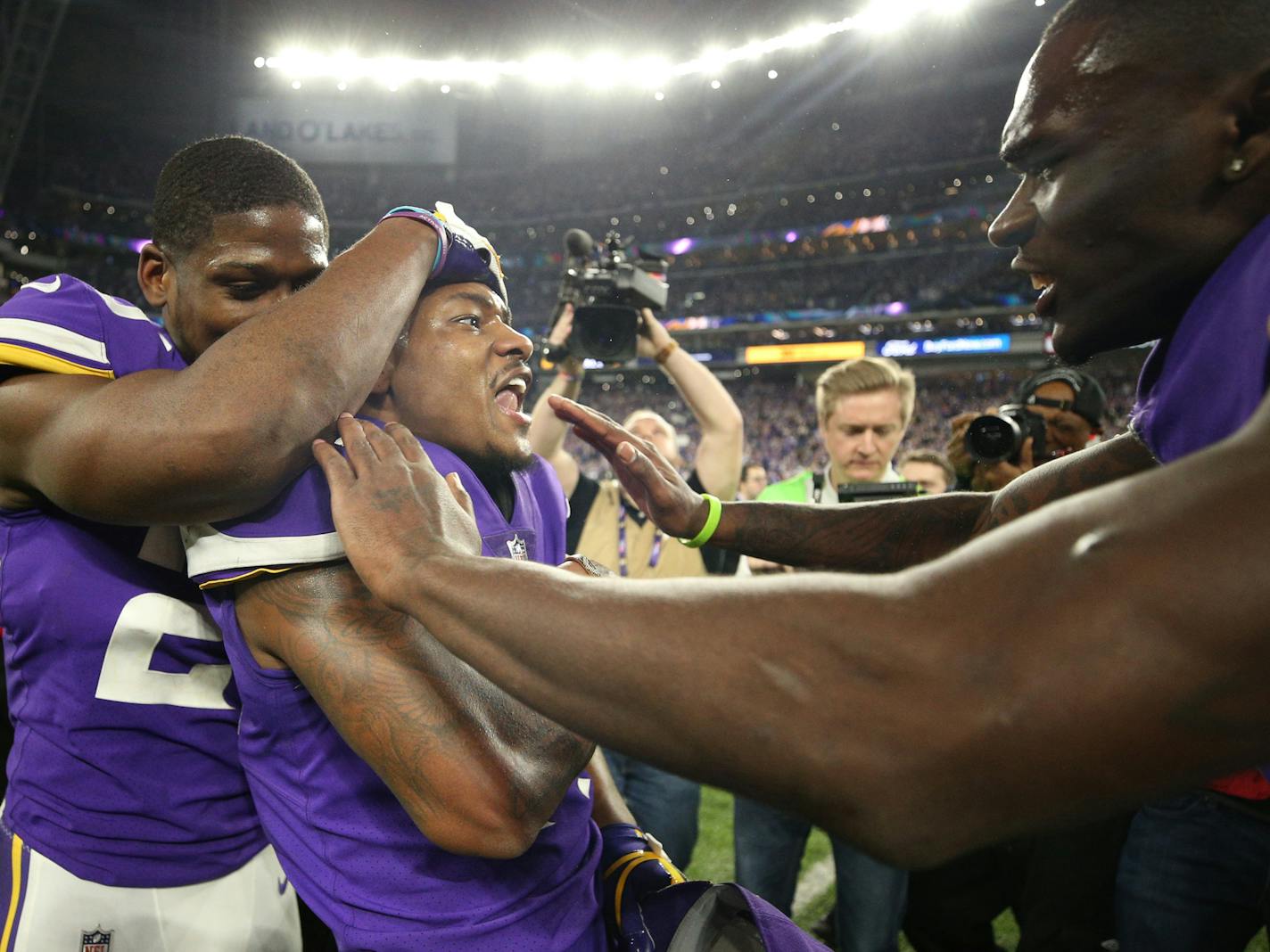 Vikings cornerback Xavier Rhodes, left, and safety Jayron Kearse, right, sandwich receiver Stefon Diggs after Diggs' 61-yard winning touchdown reception Sunday. ] JERRY HOLT &#xd4; jerry.holt@startribune.com The Minnesota Vikings faced the New Orleans Saints in an NFL divisional playoff game Sunday afternoon, January 14, 2018 a t U.S. Bank Stadium in Minneapolis.