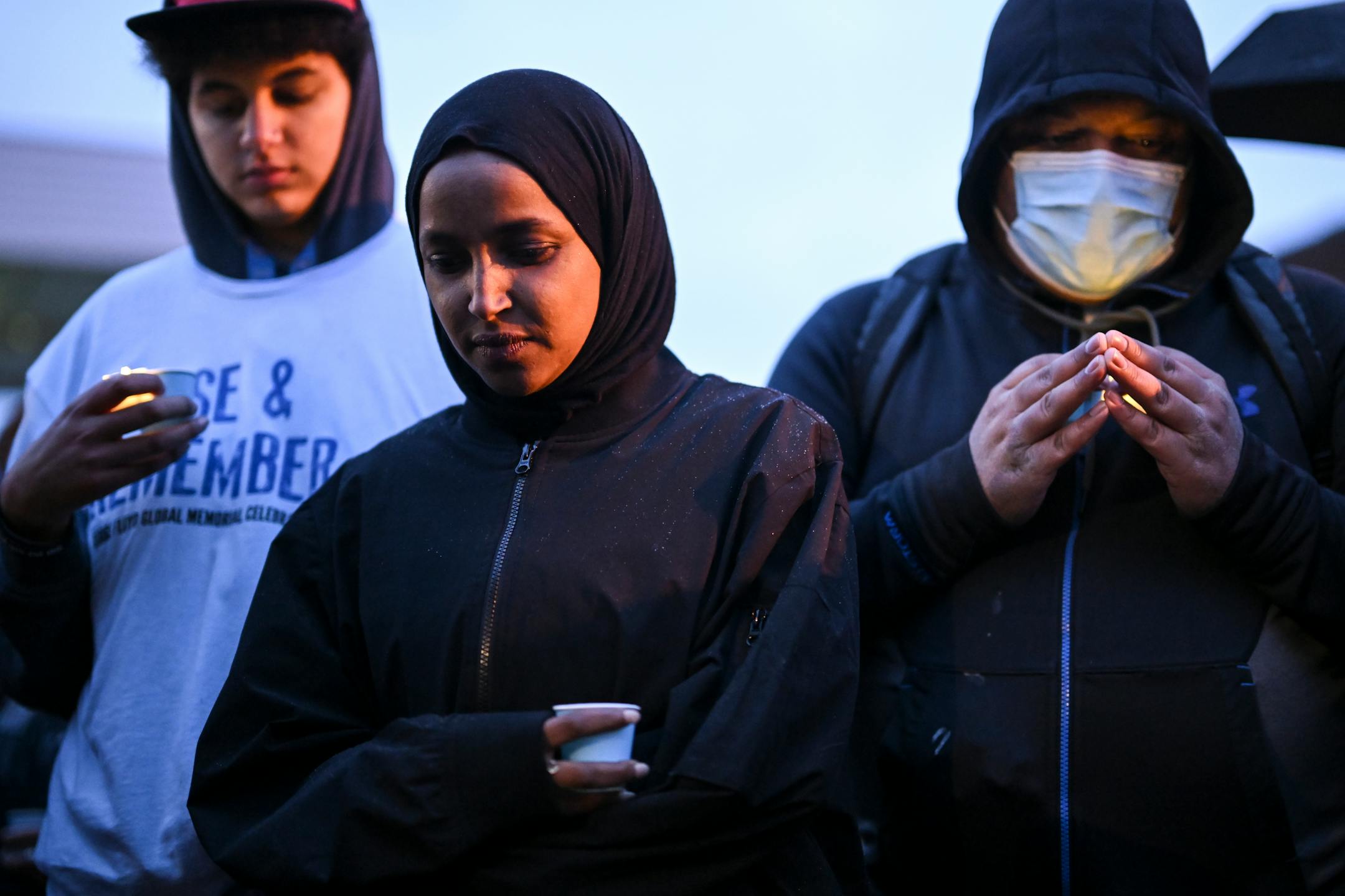 U.S. Rep. Ilhan Omar bows her head in a moment of silence at George Floyd Square on Wednesday in Minneapolis. Community members gather for the second "Angelversary" of George Floyd's murder by ex-Minneapolis Police officer Derek Chauvin. A George Perry Floyd Square commemorative street sign was unveiled at 38th and Chicago and a candlelight vigil at "Say their Names" cemetery was held blocks away.
