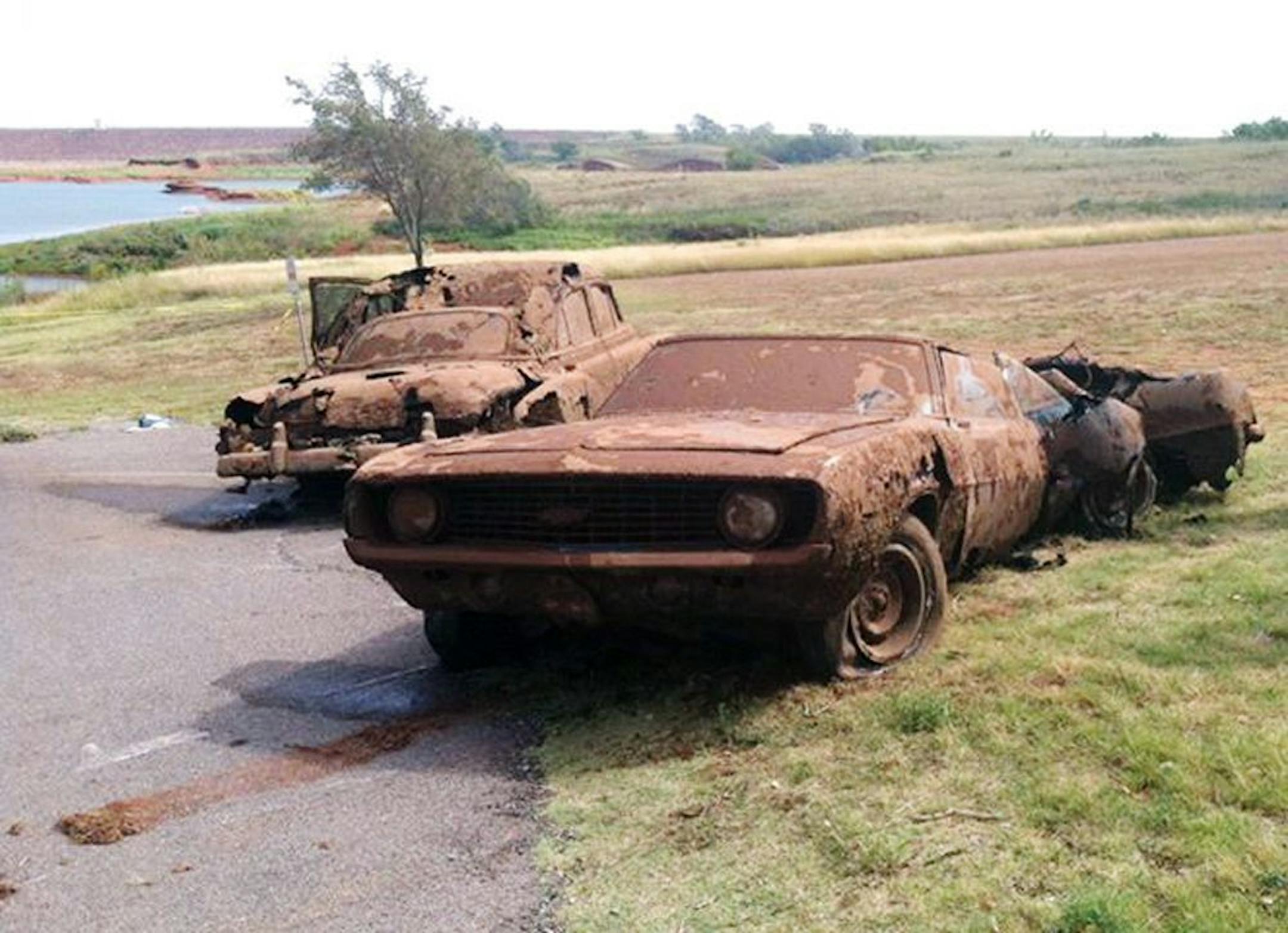 This Sept. 17, 2013, photo shows two cars recovered from Foss Lake, Okla.