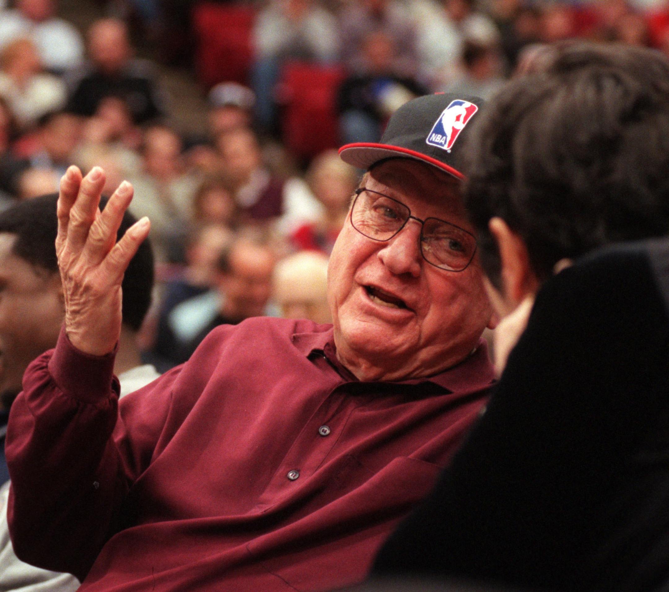 GENERAL INFORMATION: Since suffering a stroke in May, Marv Wolfenson struggles with aphasia which has robbed him of some of his communication skills.
IN THIS PHOTO: Minneapolis, Mn., Tues., Dec. 5, 2000--Marv Wolfenson talks with Marge Weiser during halftime of the Timberwolves-Chicago Bulls game Dec. 5th. Marge and Irv Weiser sit near Wolfenson on the court at the games.