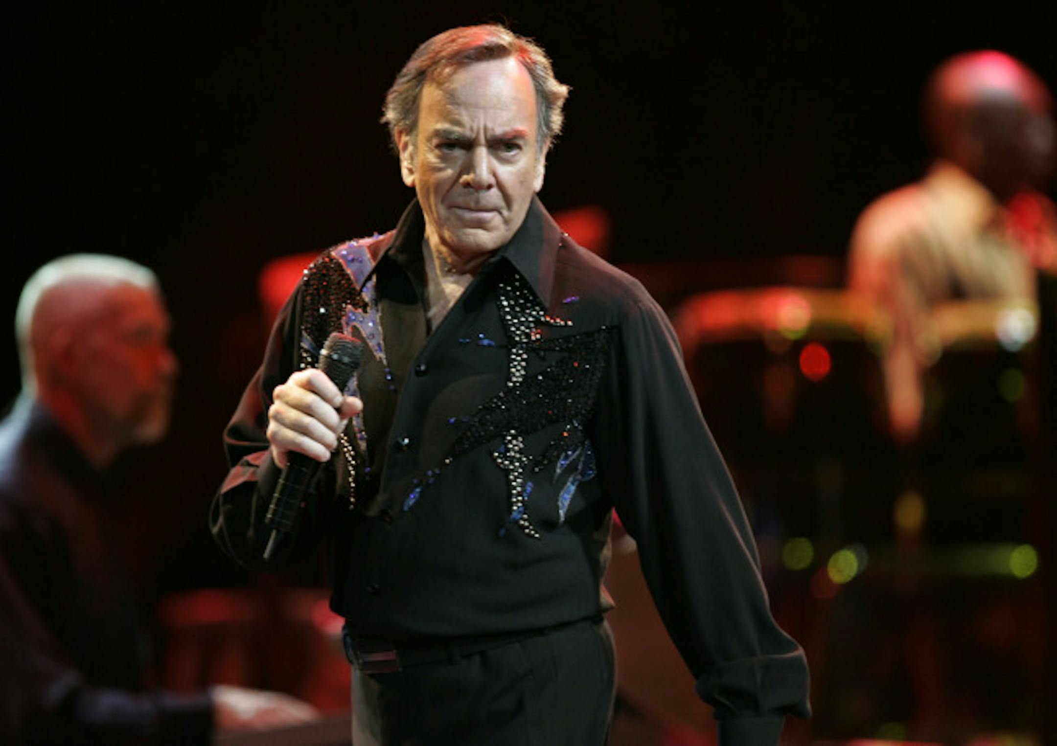 Singer Neil Diamond performs, Thursday, Aug. 18, 2005, at Madison Square Garden in New York during his world tour. Diamond will perform in concert this summer at Fenway Park. The singer made the announcement in a big-screen broadcast at the Boston Red Sox home opener Tuesday, April 8, 2008 during the traditional eighth-inning sing-along of his "Sweet Caroline," which has become an anthem for Boston fans.
