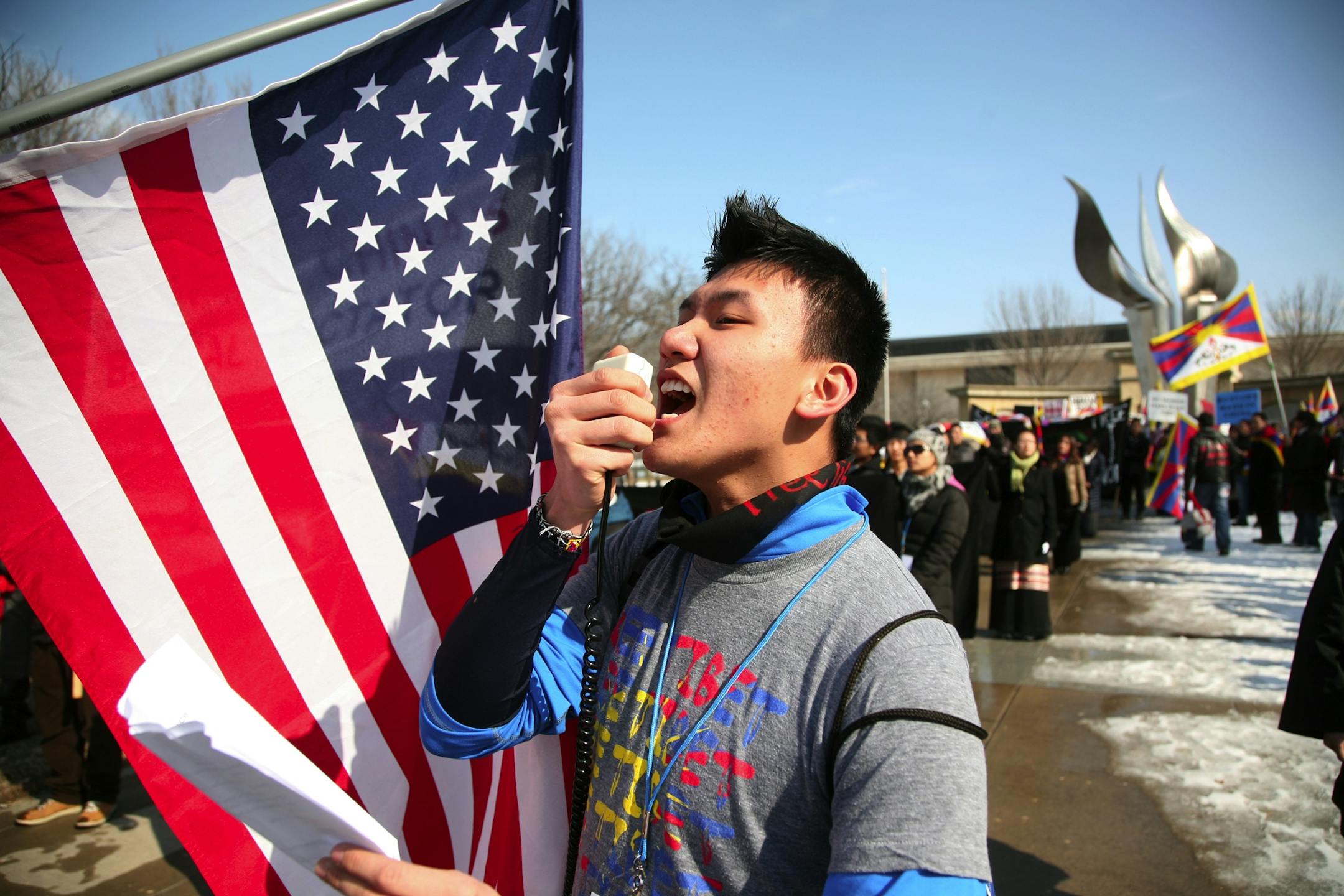 Tenzin Sonam of Richfield spoke to a large group of Tibetans, many from Minnesota, who gathered in Des Moines, Iowa, to protest on Wednesday.