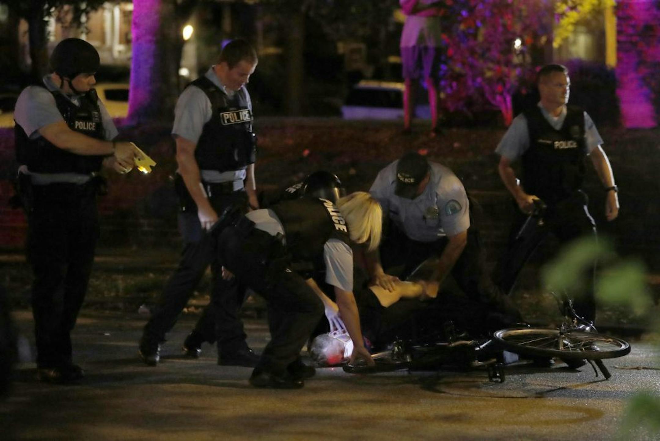Police arrest a protester as protesters gather, Friday, Sept. 15, 2017, in St. Louis, after a judge found a white former St. Louis police officer, Jason Stockley, not guilty of first-degree murder in the death of a black man, Anthony Lamar Smith, who was fatally shot following a high-speed chase in 2011.