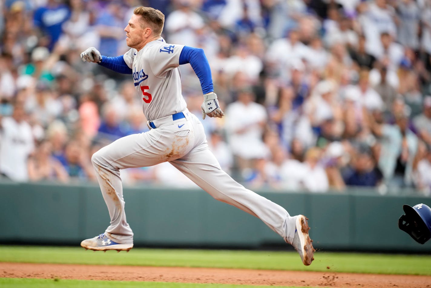 Los Angeles Dodgers' Freddie Freeman runs to third base after hitting a triple off Colorado Rockies starting pitcher Kyle Freeland in the third inning of a baseball game Saturday, July 30, 2022, in Denver. (AP Photo/David Zalubowski)