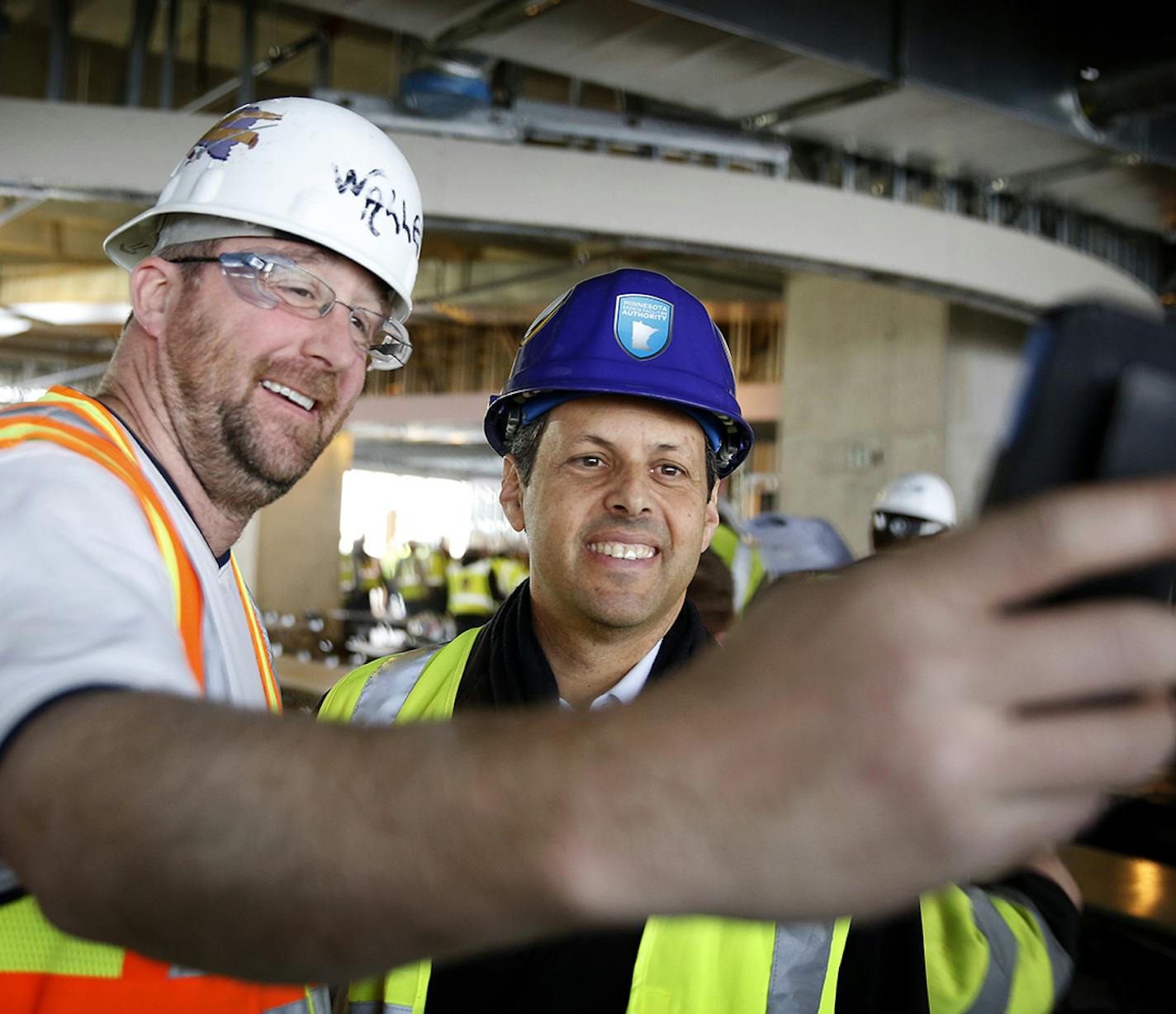 Carpenter Chad Canesi takes a selfie with Minnesota Vikings owner Mark Wilf during a free lunch for construction workers at the NFL football team's new stadium on Friday, Dec. 12, 2014, in Minneapolis. (AP Photo/The Star Tribune, Leila Navidi) MANDATORY CREDIT; ST. PAUL PIONEER PRESS OUT; MAGS OUT; TWIN CITIES LOCAL TELEVISION OUT ORG XMIT: MIN2014121221511069