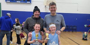 Paul Blume (left) and his daughter, Beatrice, alongside Lou Raguse and his daughter, Violet, after their team won a championship.