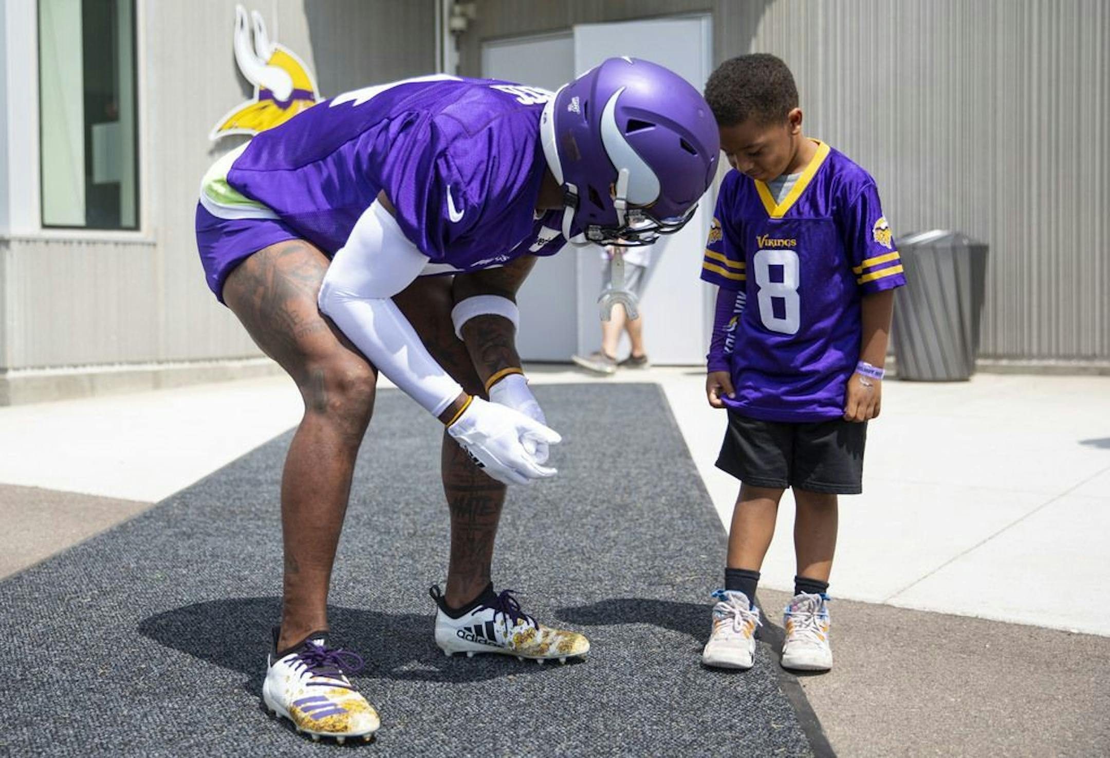 Minnesota Vikings wide receiver Stefon Diggs (14) picks up a smiling four-year-old Braydan Lankford before practice. Lankford waited specifically for Diggs to walk out so he could meet him. ALEX KORMANN • alex.kormann@startribune.com The Minnesota Vikings opened up their first full day of training camp on Friday July 26, 2019 at TCO Performance Center in Eagan, MN. Doors opened to fans at 11AM to watch their favorite players practice and get excited for the 2019 NFL season.