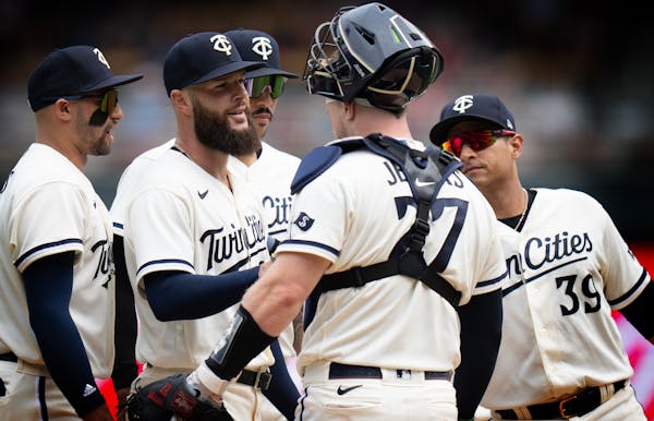 Dallas Keuchel (60) was surrounded by teammates after he was pulled from the game in the seventh inning. 