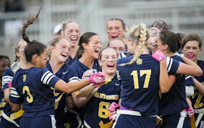 Mahtomedi players celebrate their flag football state championship Monday at TCO Stadium.