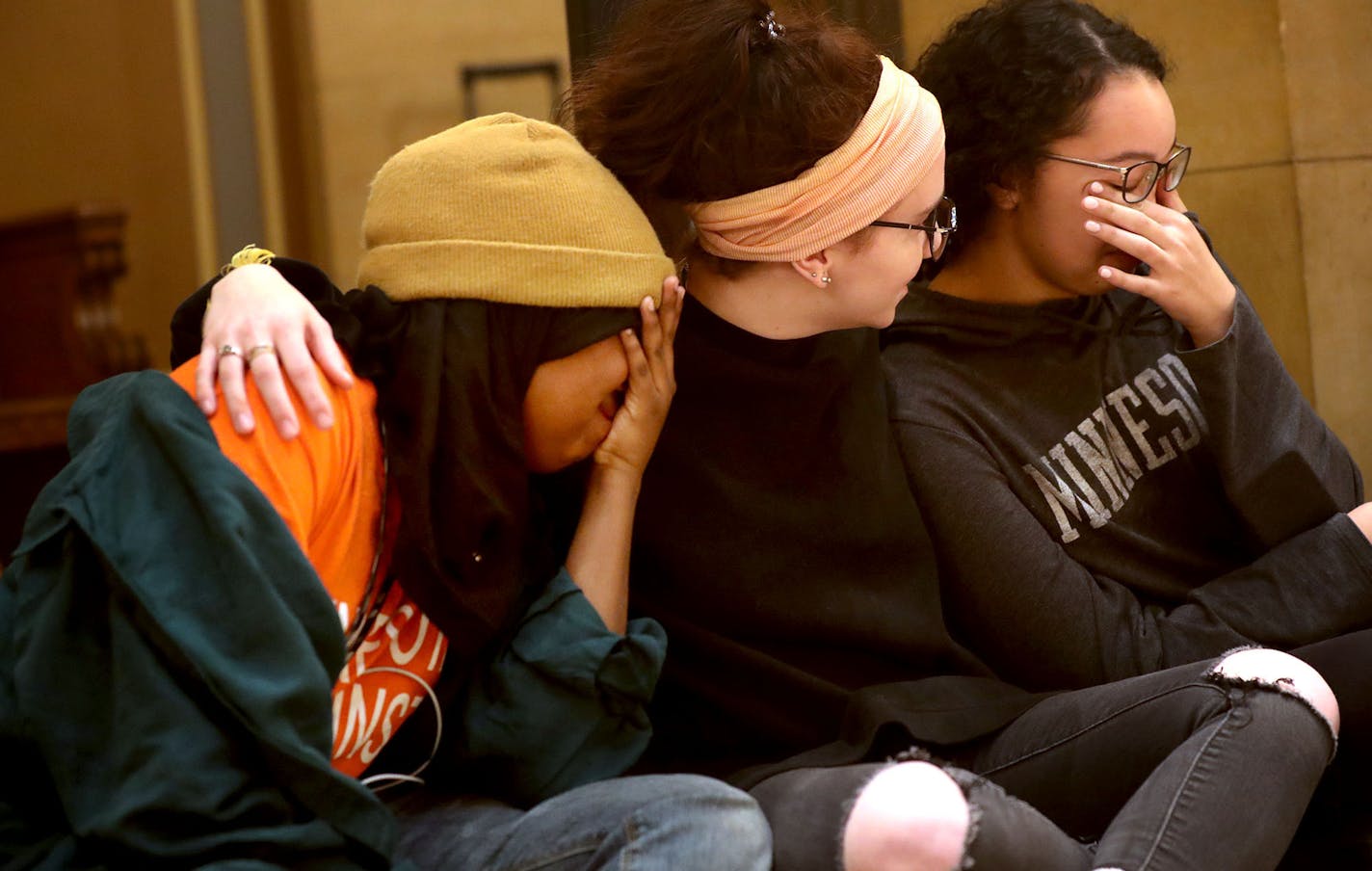 Protect Minnesota and gun control advocates marked the first anniversary of the Parkland shootings and other gun deaths Thursday, Feb. 14, 2019, in the rotunda of the Minnesota State Capitol in St. Paul, MN. Here, friends Muna Galbayte, left to right, Anna Feist and Maya West, all of Eden Prairie, held hands as names of gun Minnesota victims from 2018 were read aloud.] DAVID JOLES &#x2022;david.joles@startribune.com Gun control advocates and Democratic lawmakers are marking the first anniversary