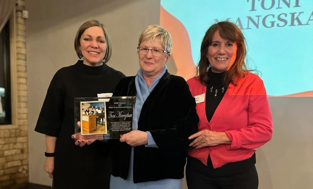 Toni Mangskau, center, received an award honoring her advocacy from AARP Minnesota. With, from left, the AARP’s Erin Parrish and Mary Jo George.