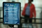 A TSA PreCheck sign signals a line at MSP airport.