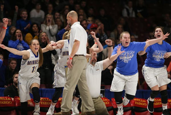 The Minneota bench rushed onto the court after defeating Goodhue 40-31 to claim the 1A state girls basketball championship on Saturday, March 16, 2019